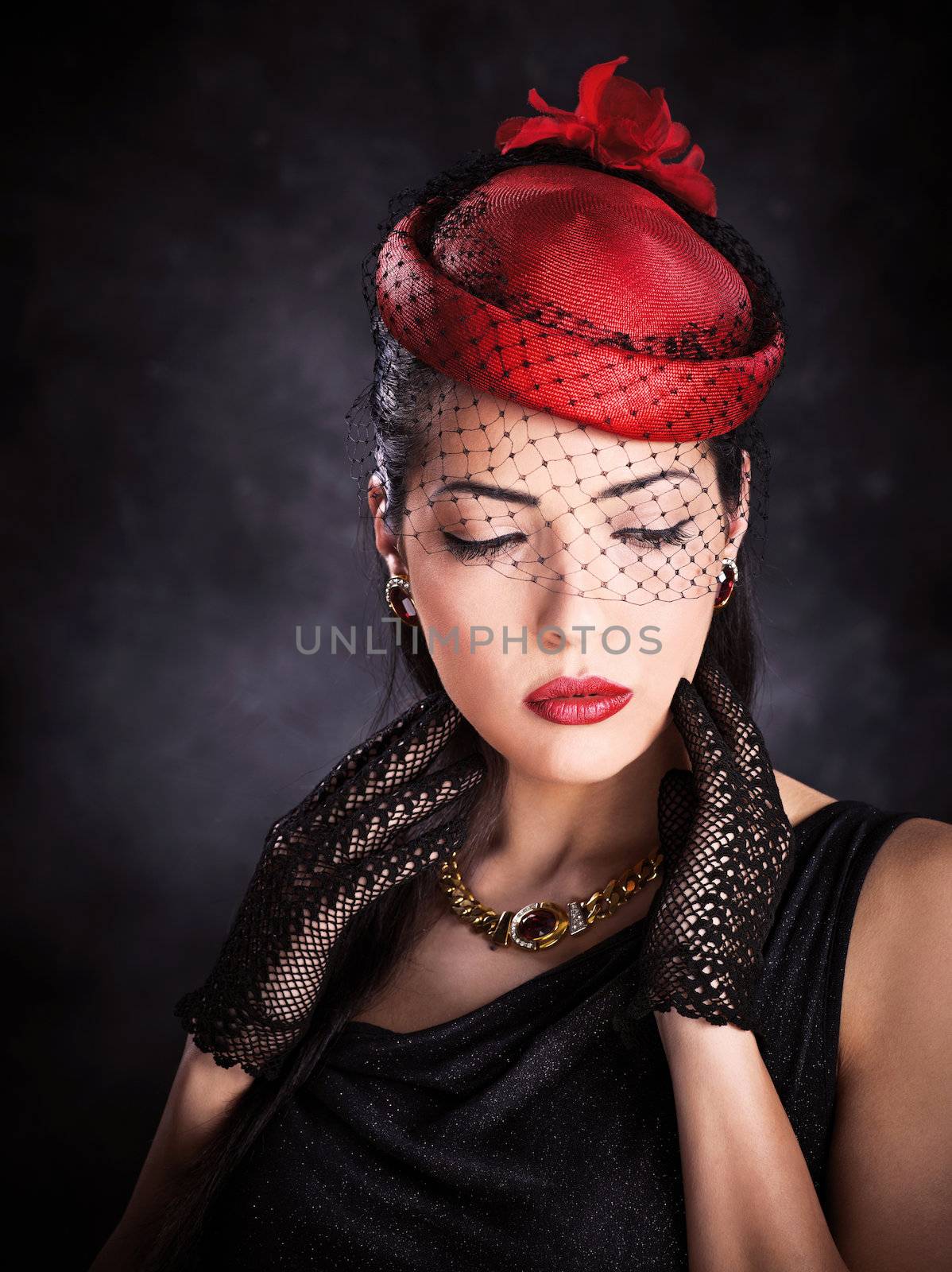 Portrait of a pretty woman with red hat and black gloves