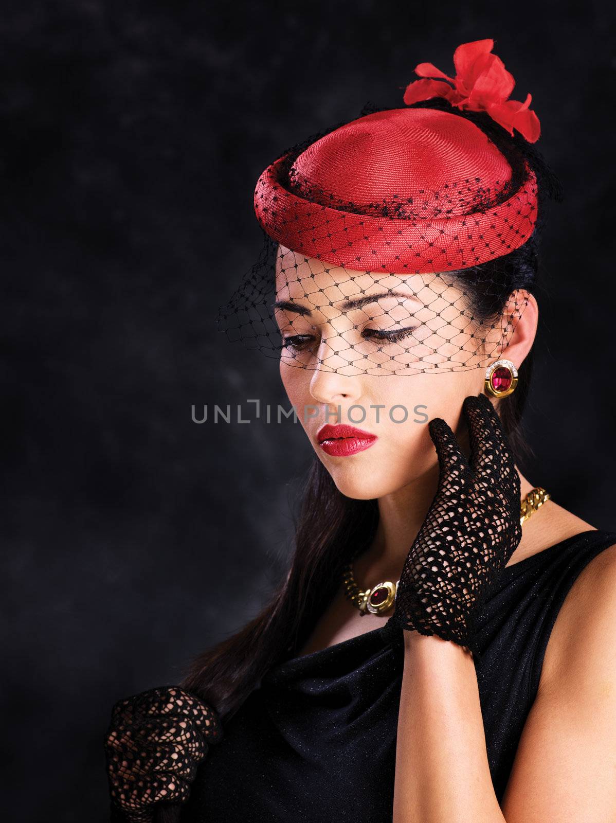 Portrait of a pretty woman with red hat and black gloves