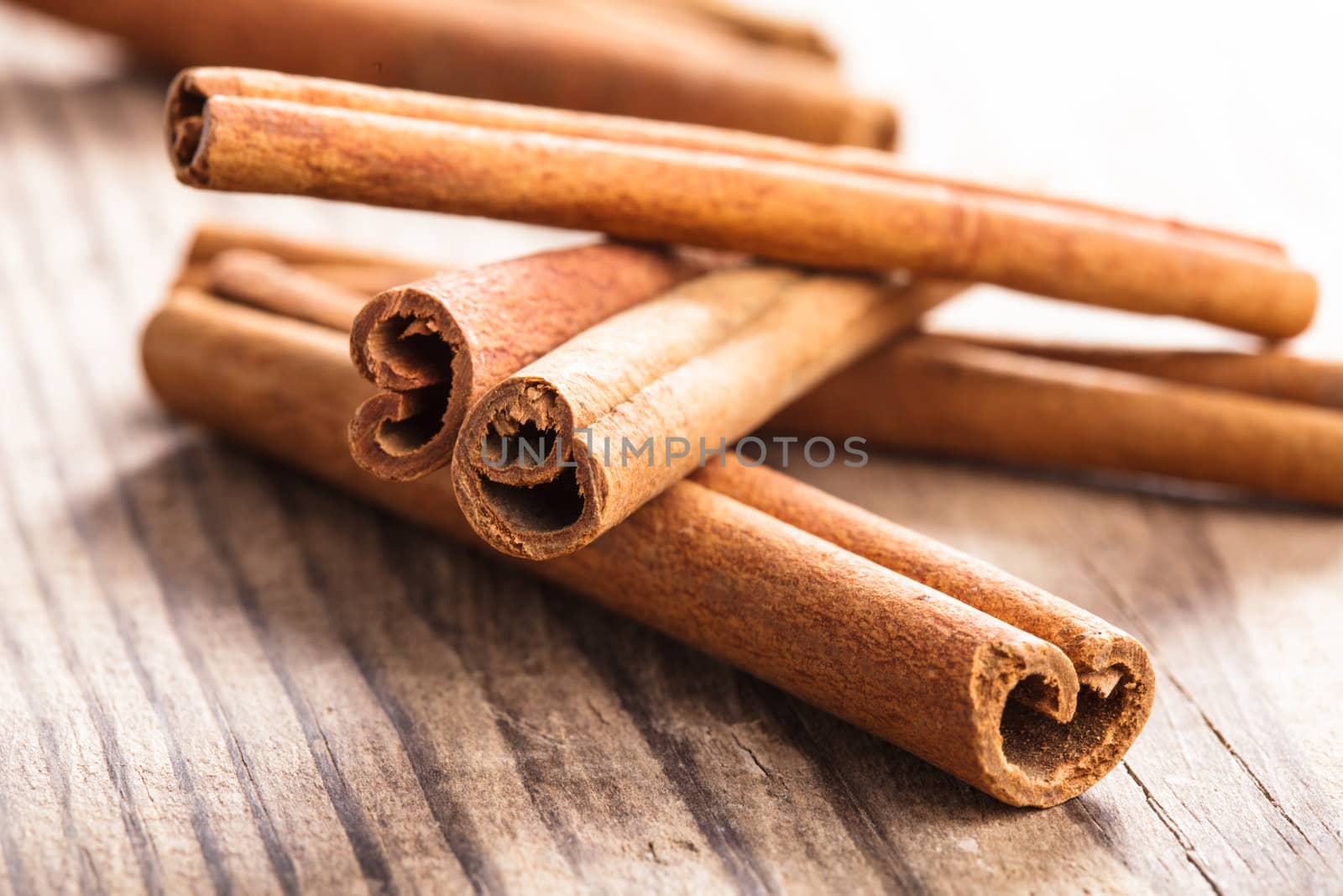 Cinnamon sticks close up on wooden table