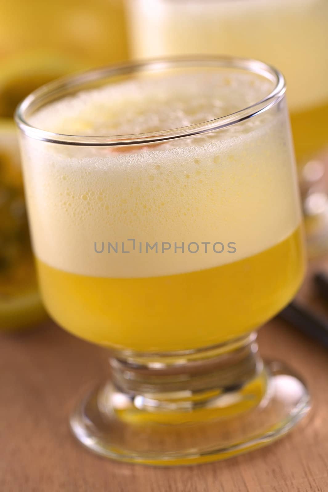 Maracuya Sour, a popular Peruvian cocktail made of maracuya and lime juice, pisco, syrup and egg white (Selective Focus, Focus on the front of the glass rim)