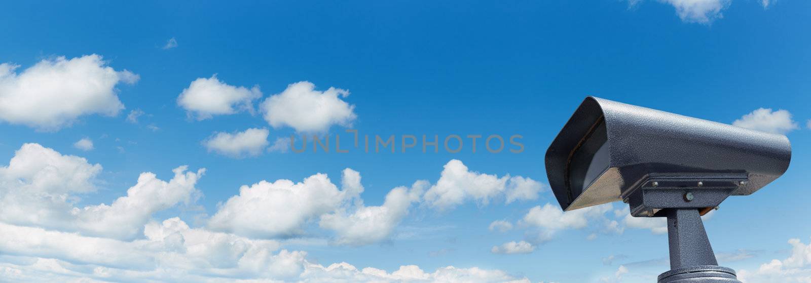 clean binoculars on blue sky background, selective focus