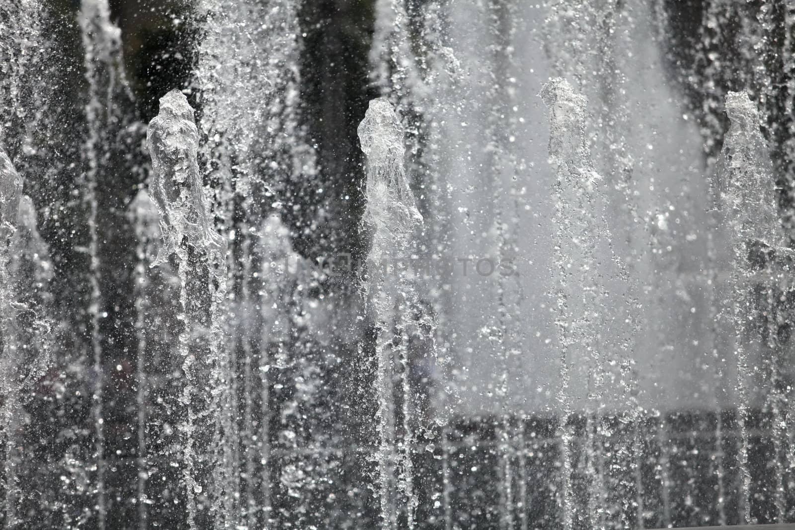 Water wall fountains from spouting vertical background, close-up