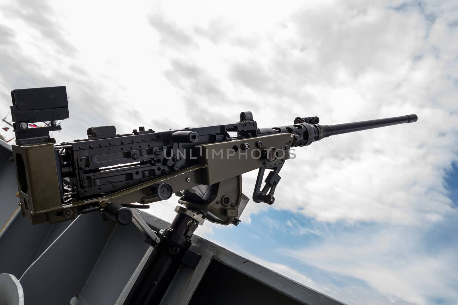 machine gun on warship against dark sky