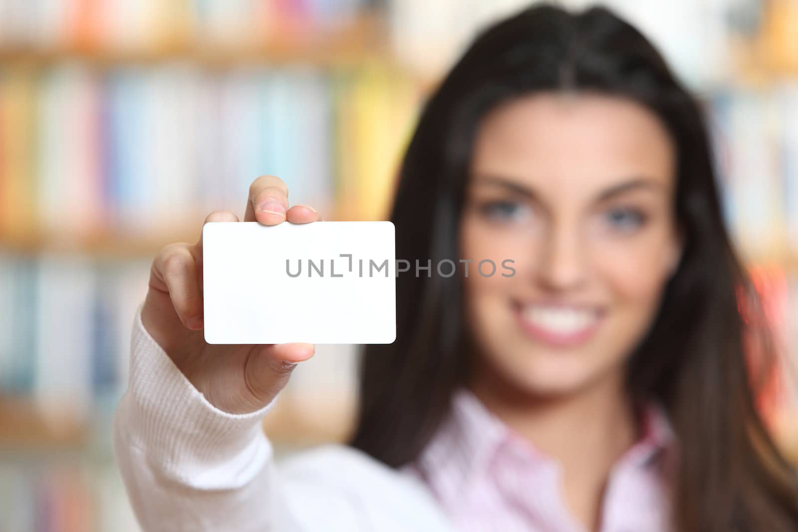 smiling young female showing a business card  -  copy space. by stokkete