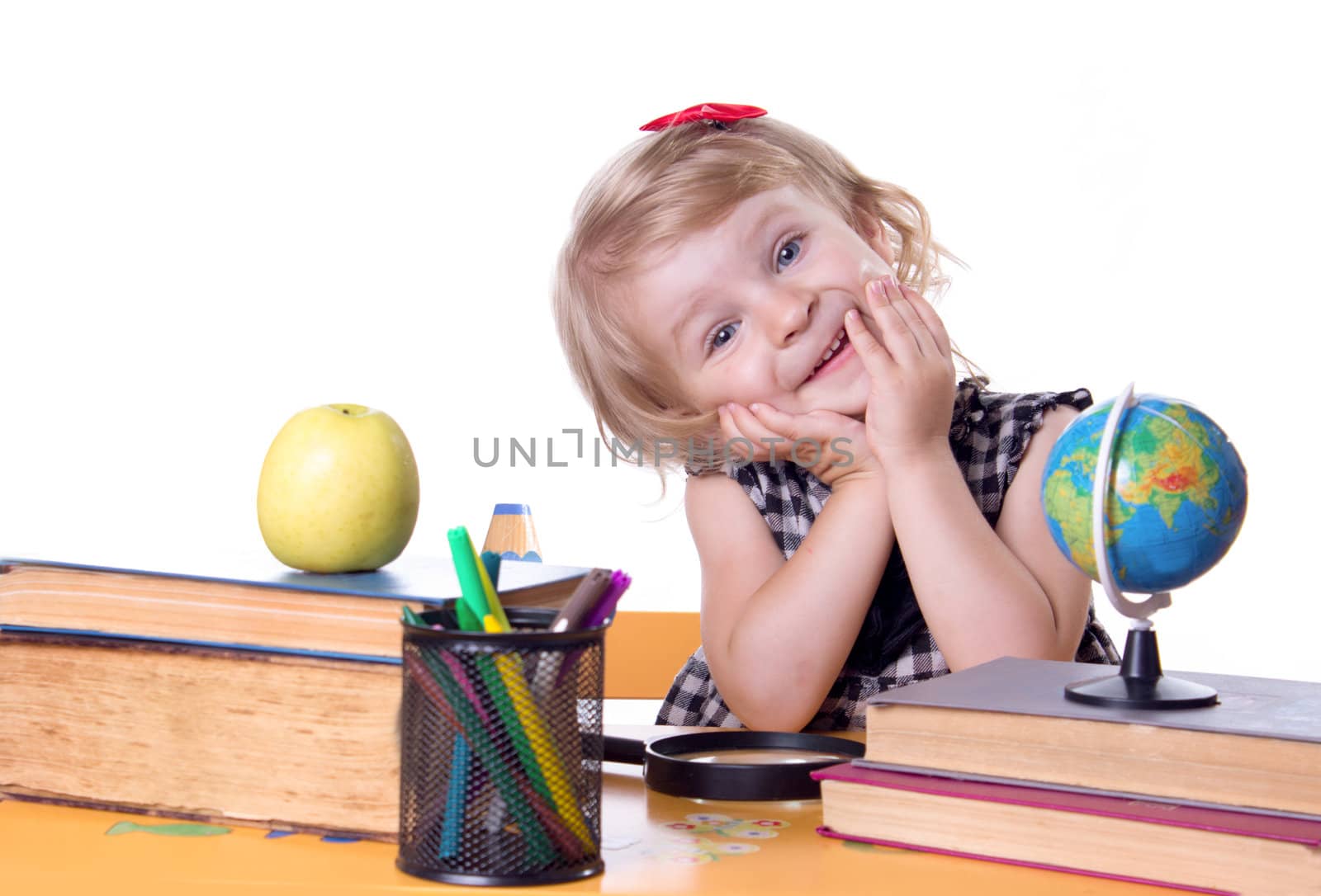 Adorable girl sitting at table with books and globe isolated on white