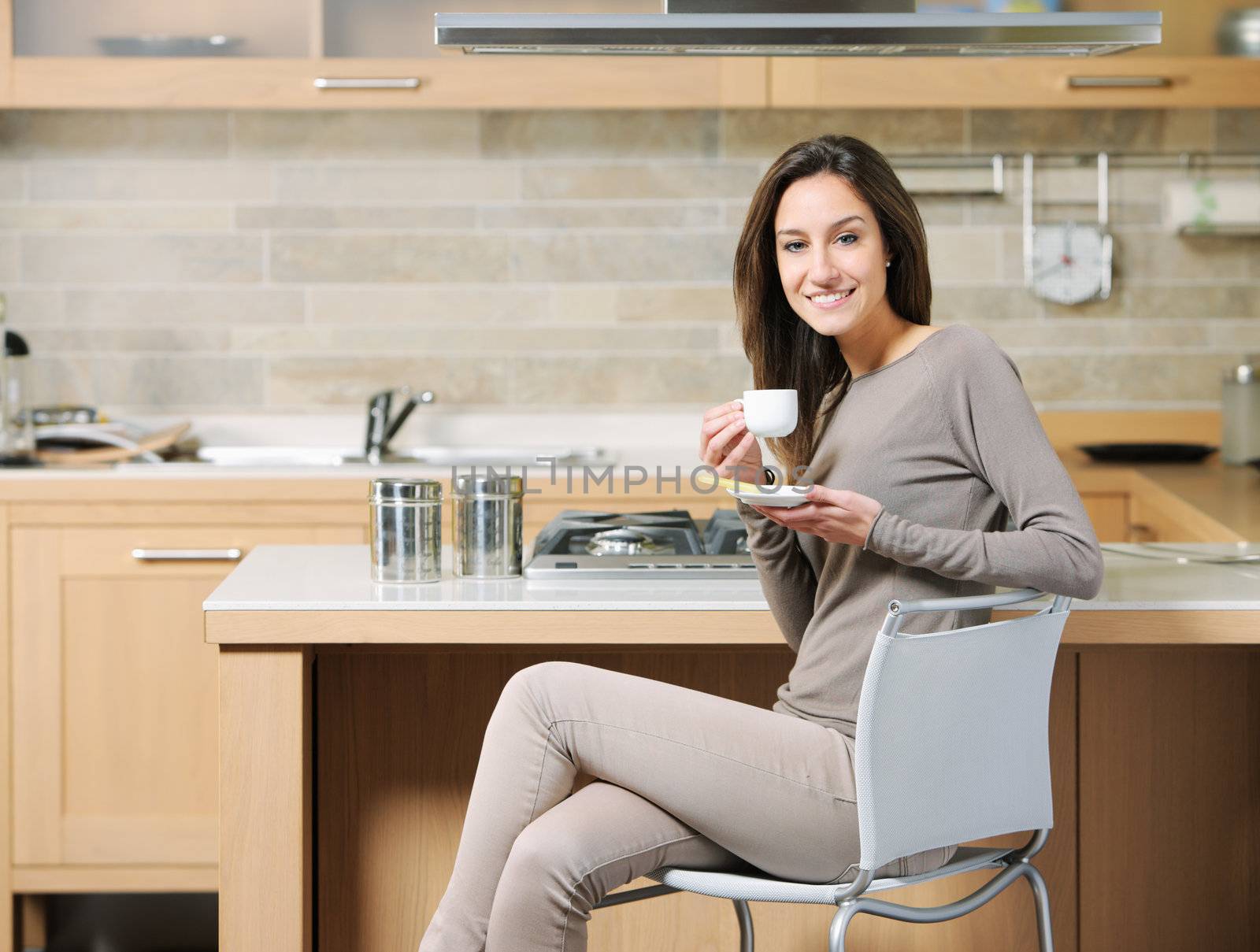 smiling woman having breakfast at home