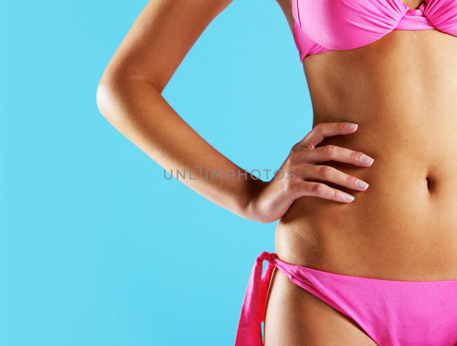 Woman wearing string bikini, close-up of abdomen