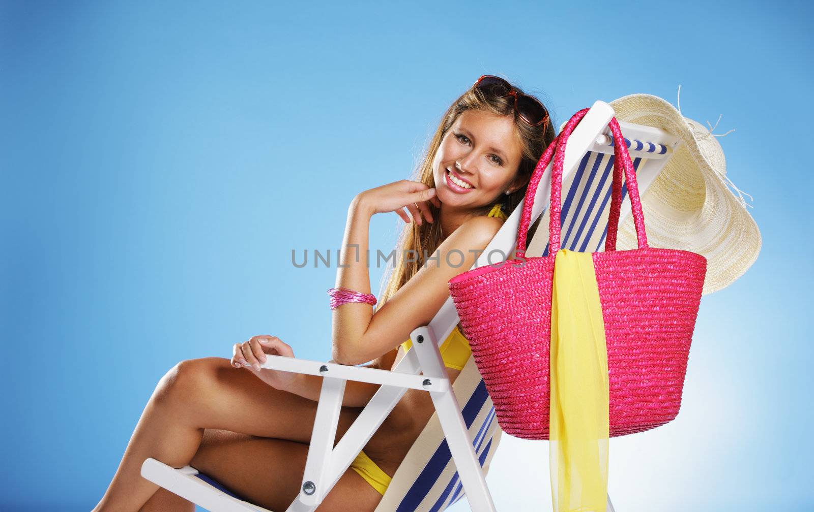 Beautiful young woman relaxing on beach chair