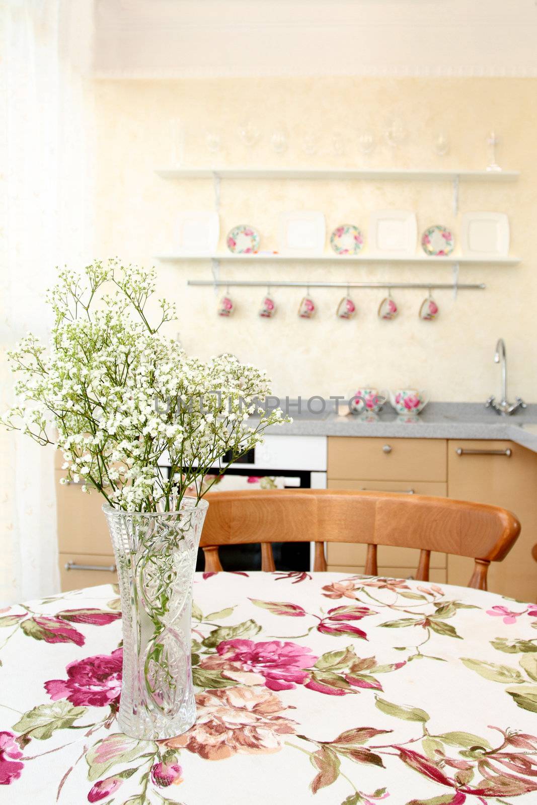 interior of the modern apartment, table with a bunch of flowers, a vertical shot