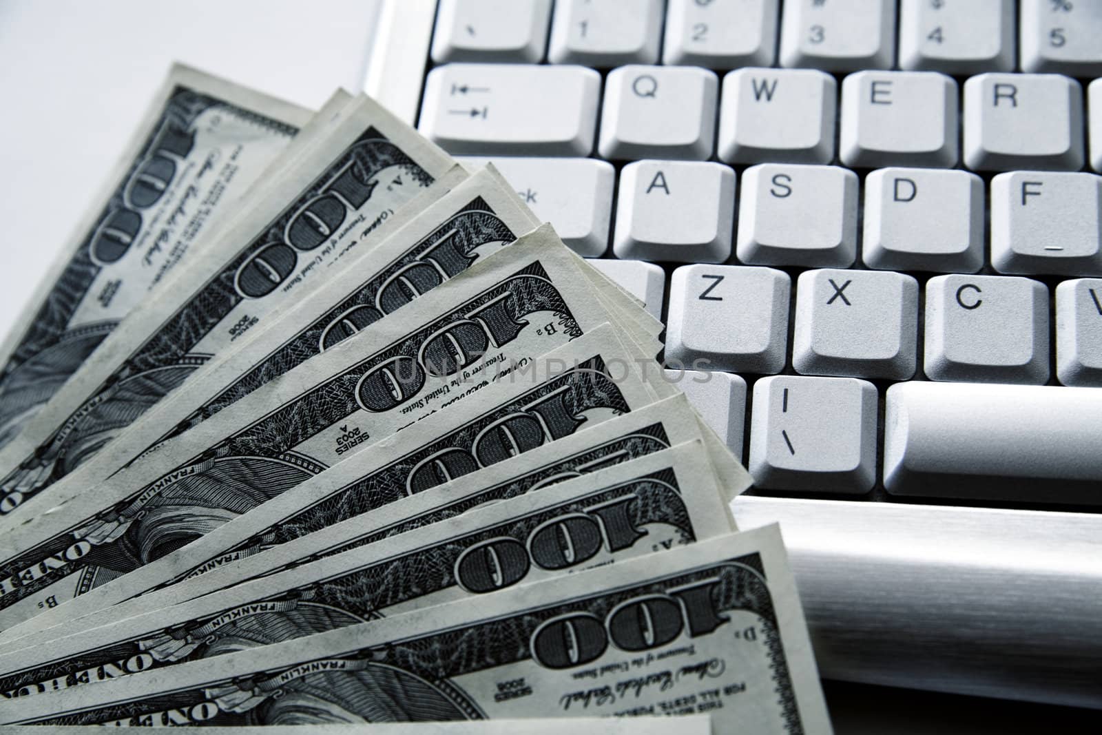 dollar banknotes on a background an aluminium computer keyboard