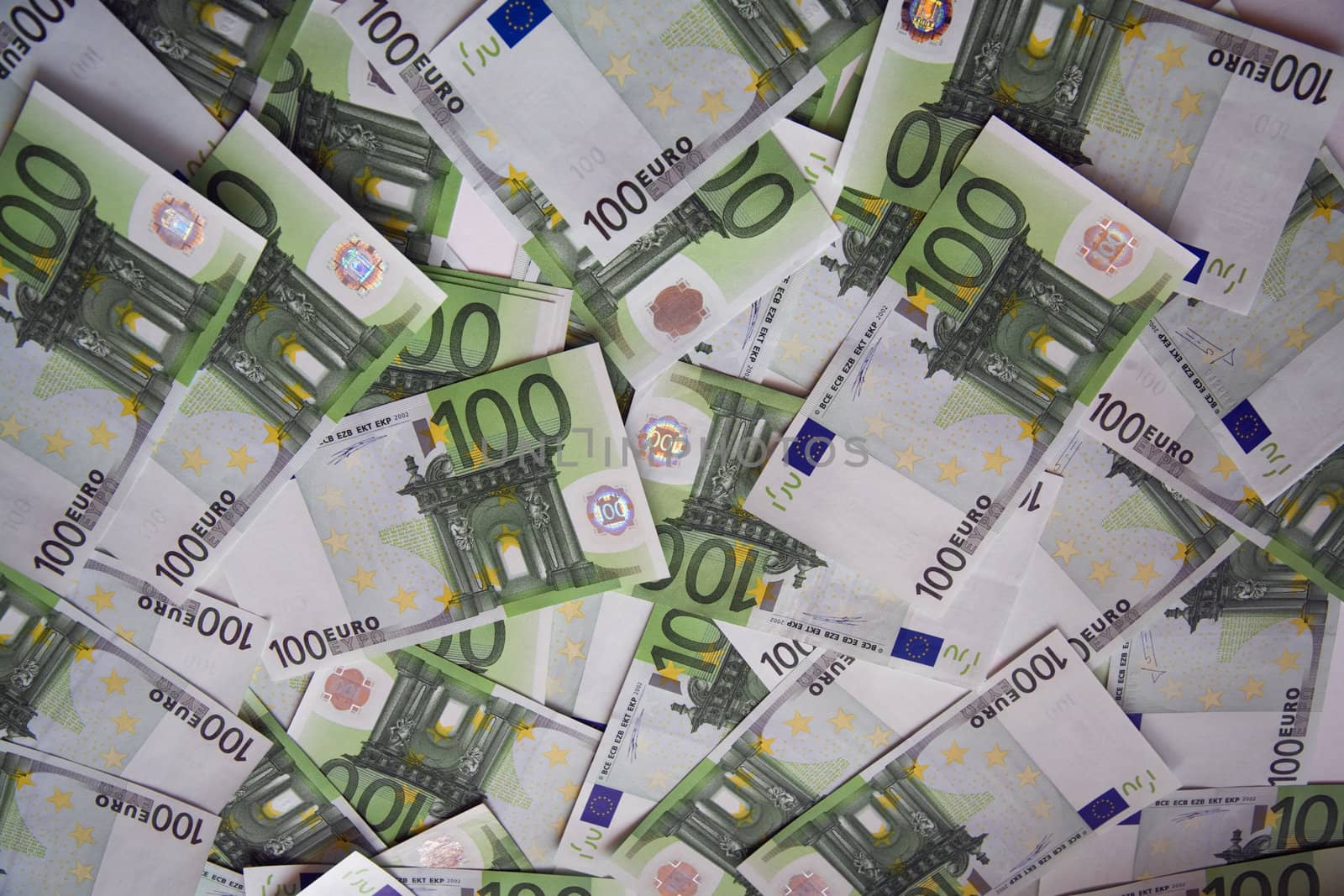 background from chaotically lyings one hundred euro banknotes