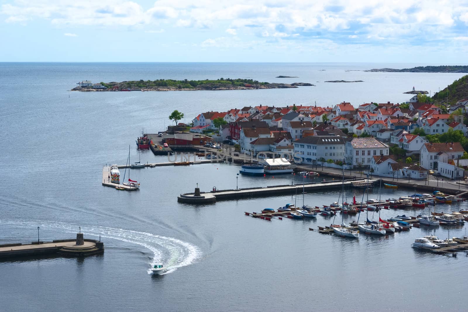 Motorboat entering the harbor of Risor in Southern Norway