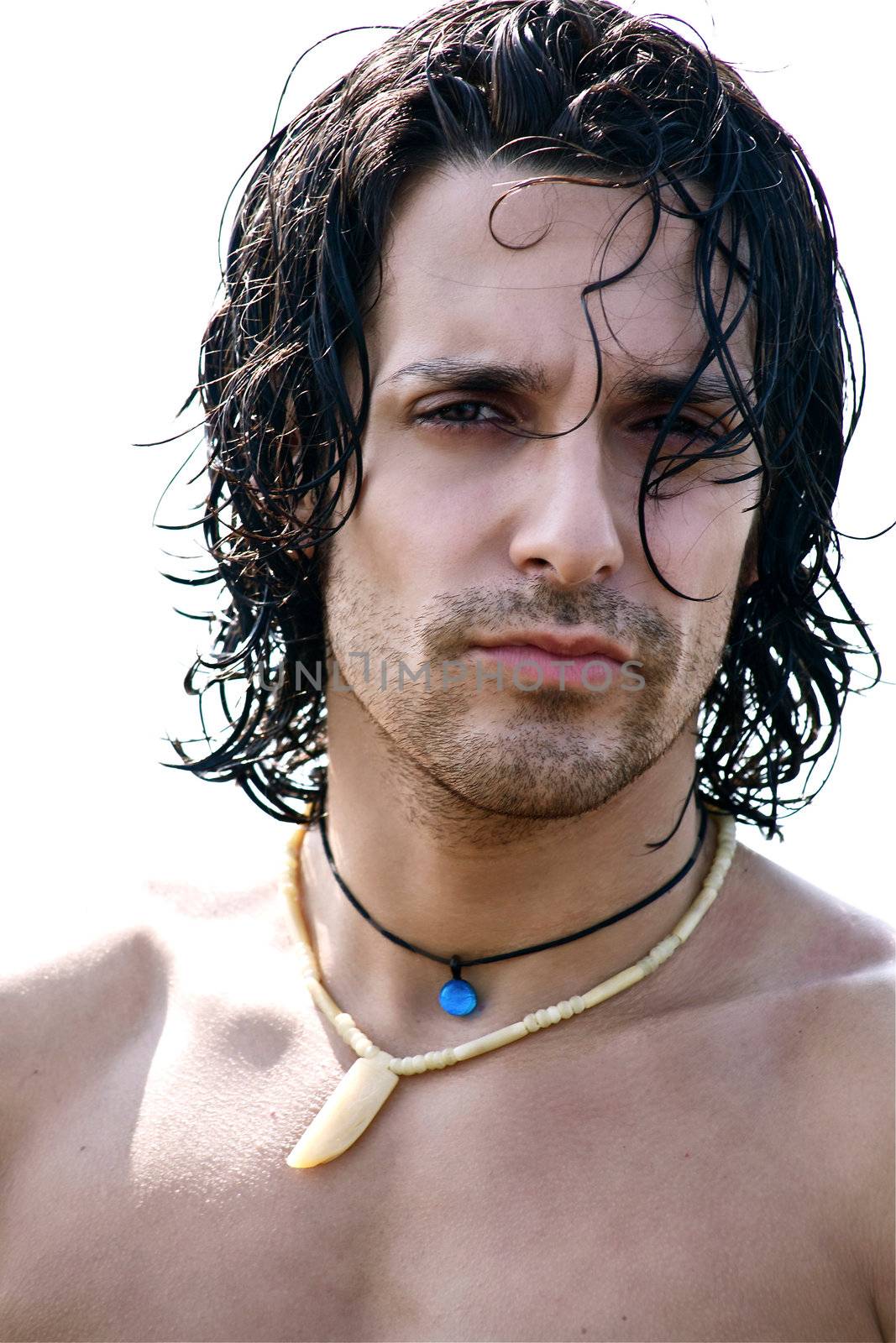 Portrait of muscular male model on the beach  by fmarsicano