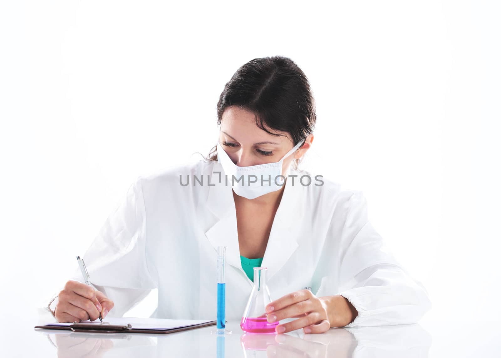 a young woman researcher working with chemicals by stokkete