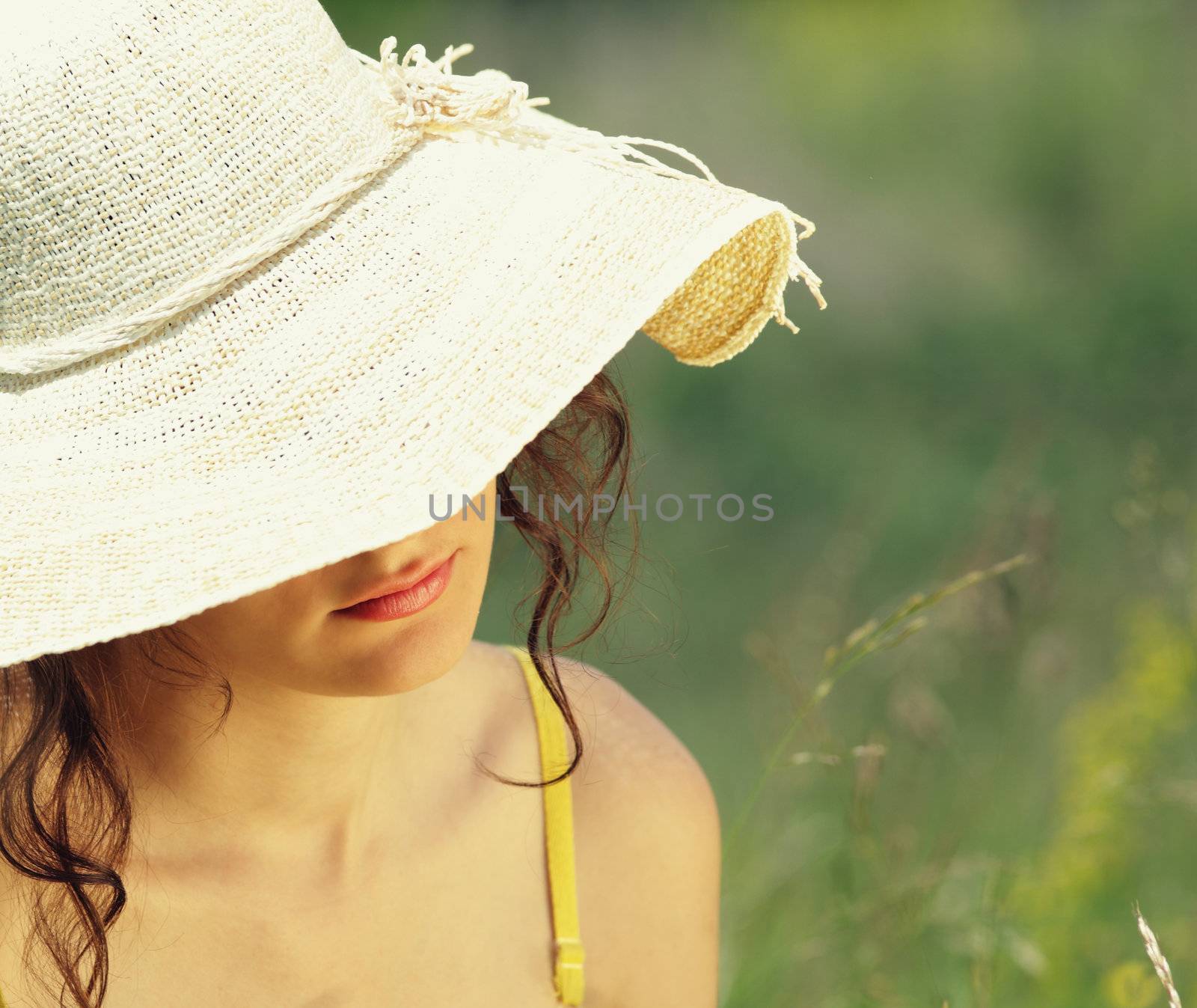 young woman in flowery field on a summer day