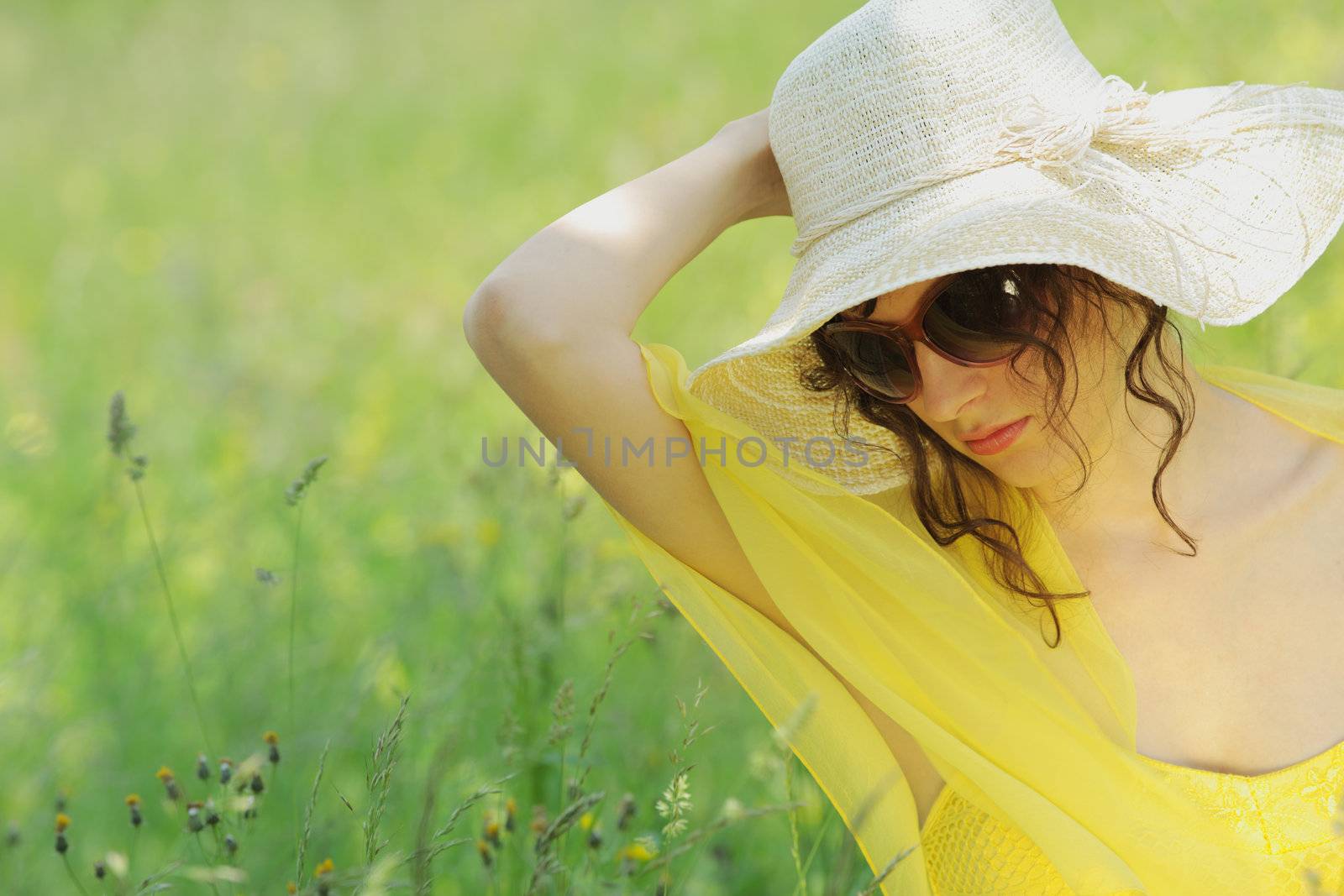 young woman in field on a summer day