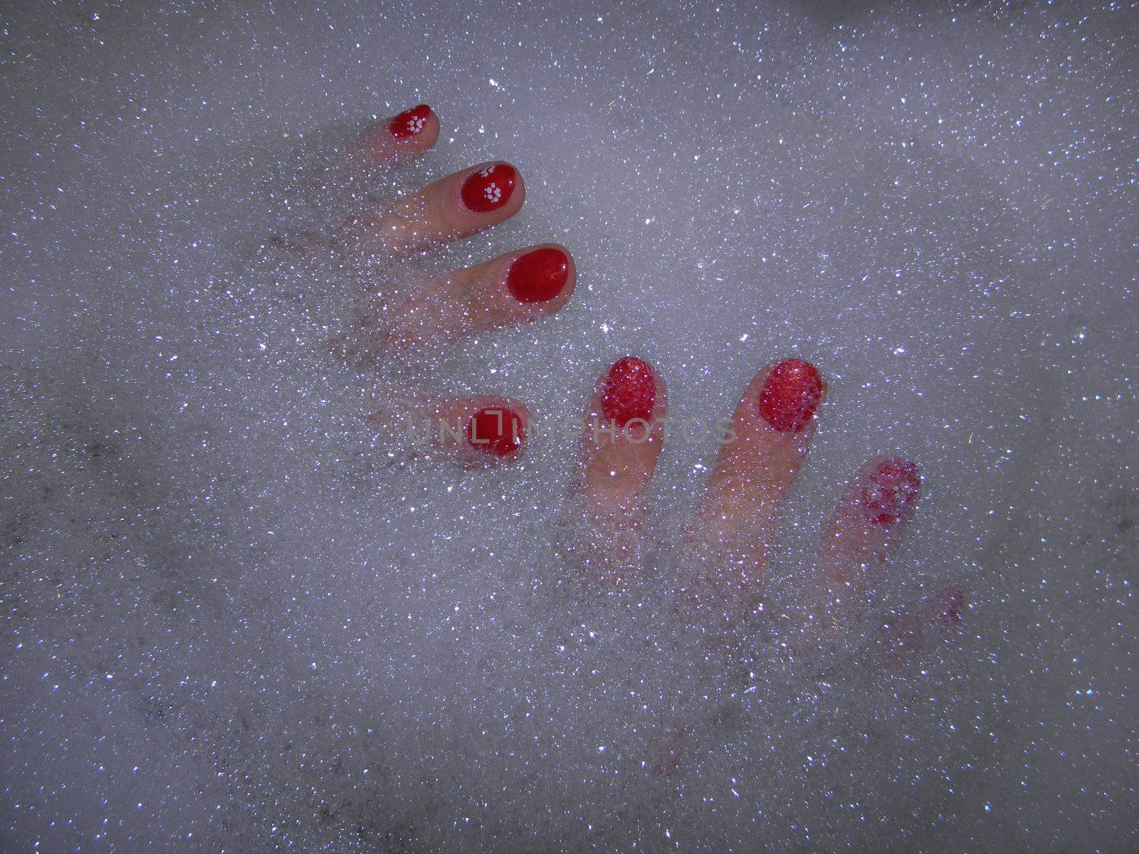 Photo by painted fingernails in the bath foam.