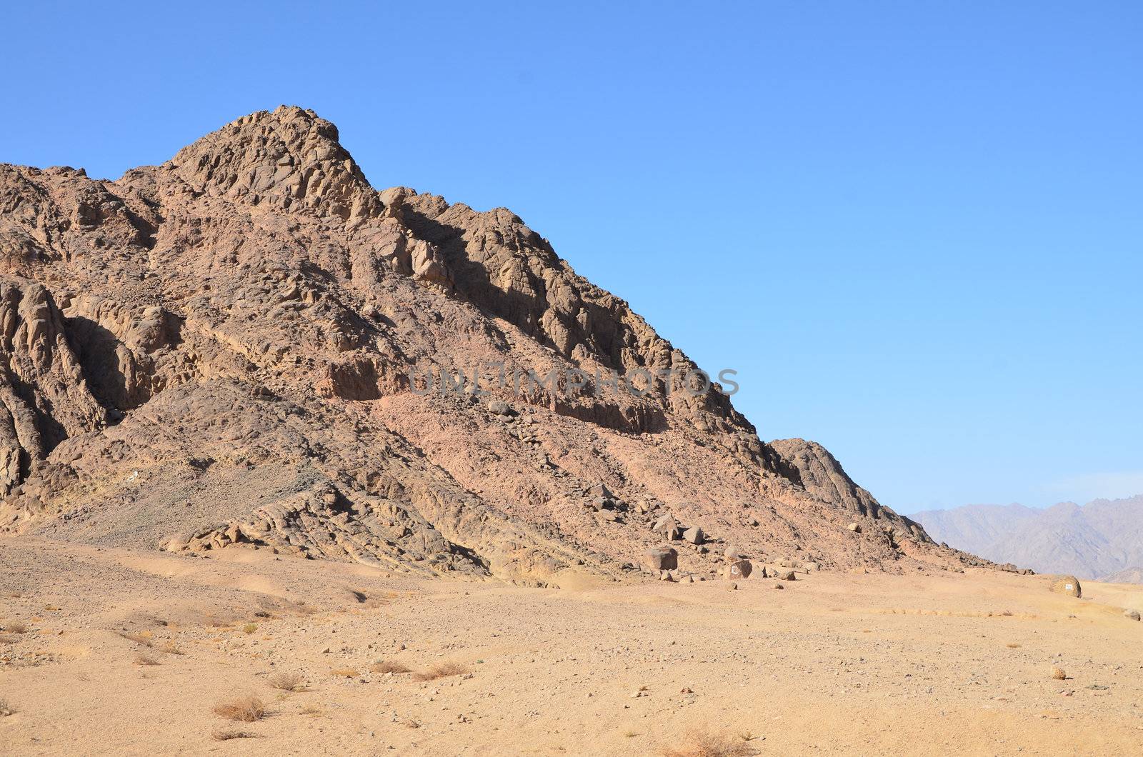  Desert landscape with dunes and rocks under bright sun