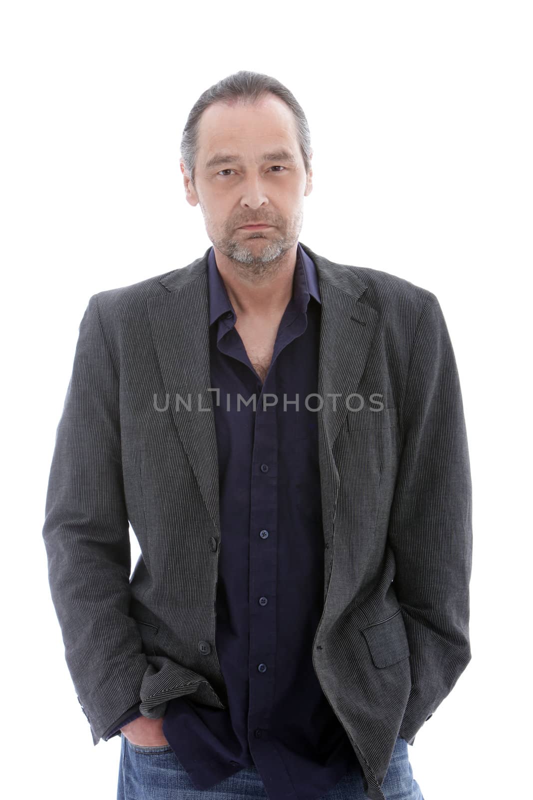 Studio shot of handsome mature man with hands in his pockets