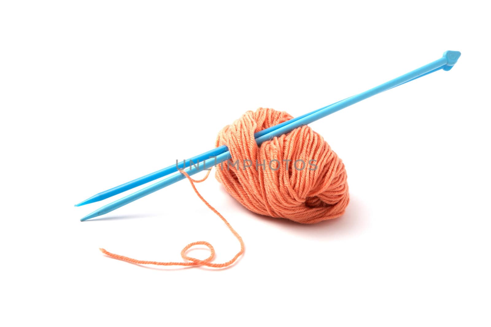 Balls of a yarn knitting spokes on white background
