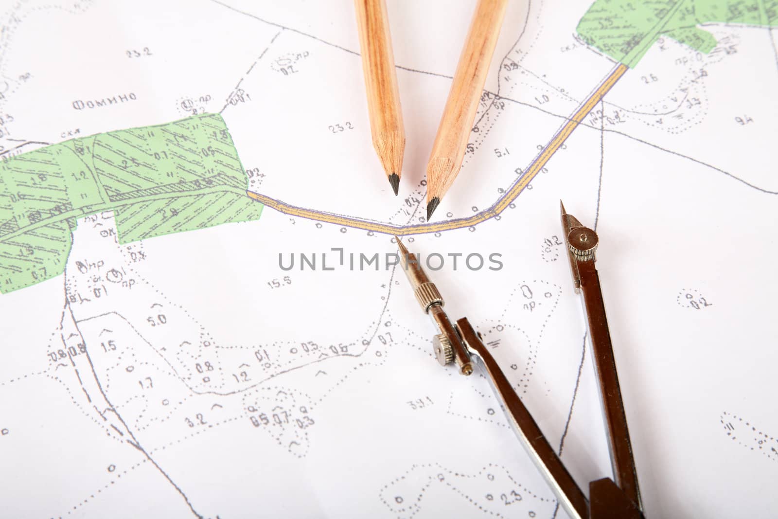 Topographic map of district with a measuring instrument and pencils