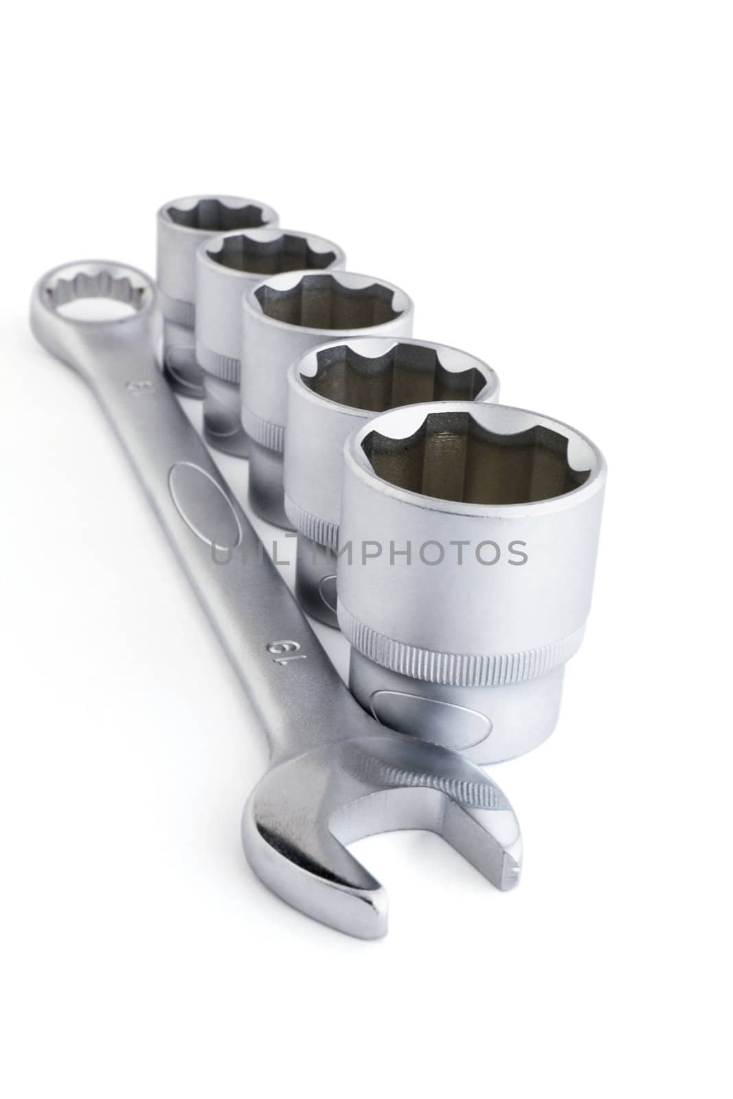 metallic wrench tools on isolated white background by Serp