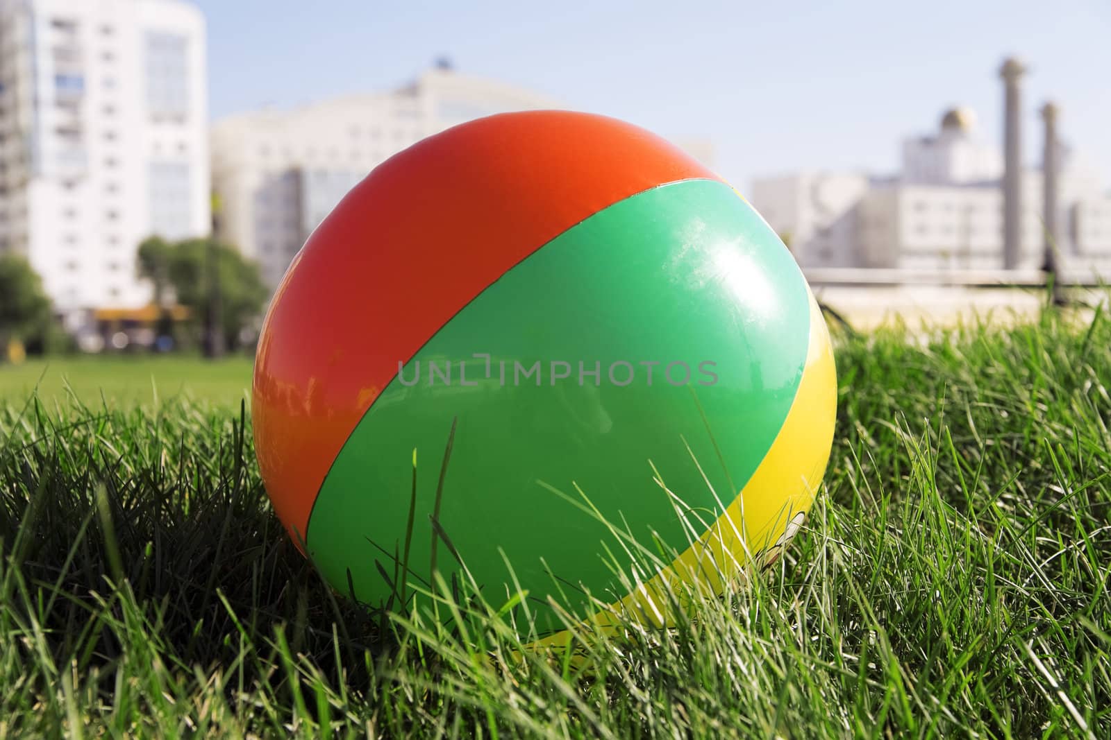 ball for outdoor games lying on grass in city park by Serp