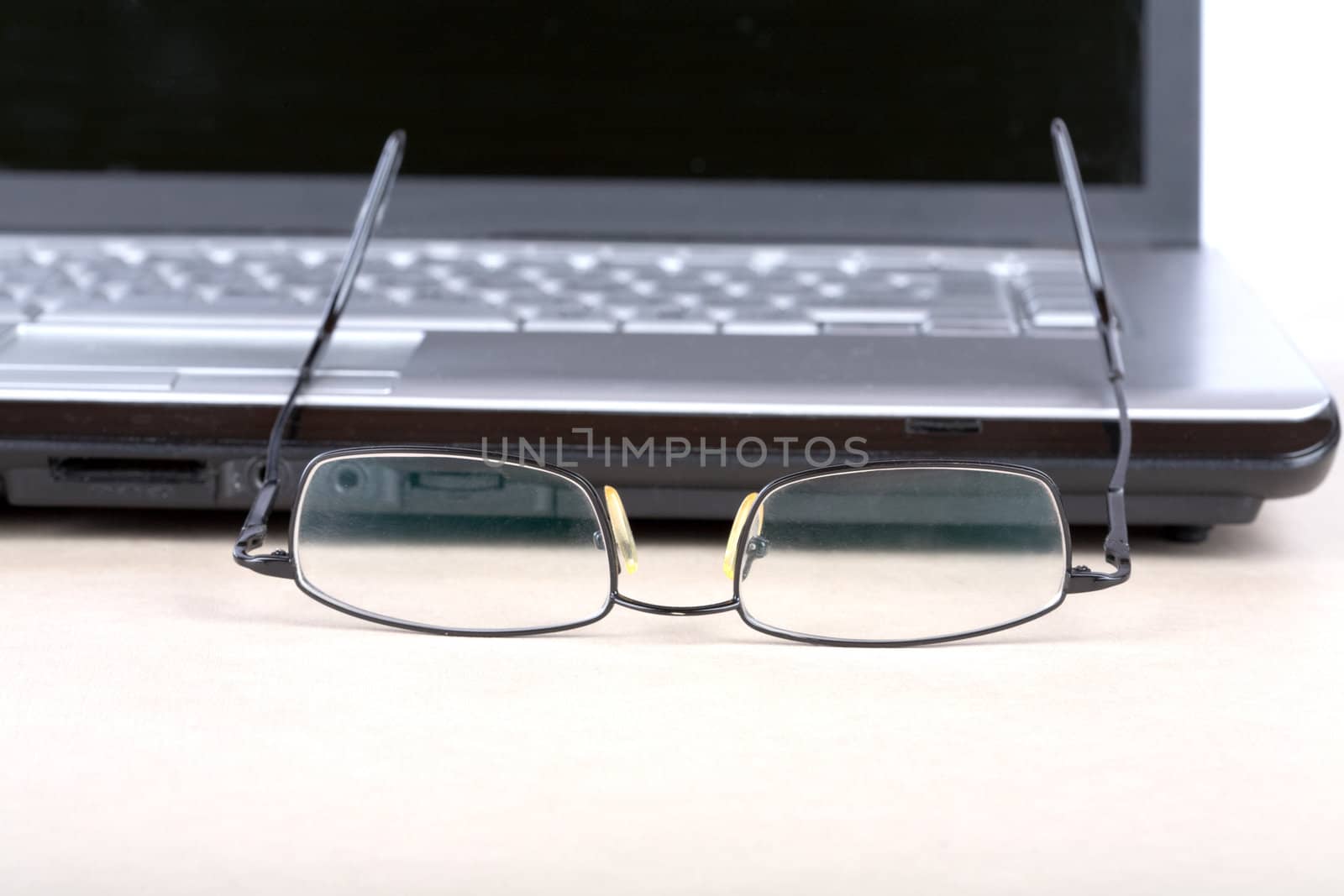  glasses and notebook on a desk