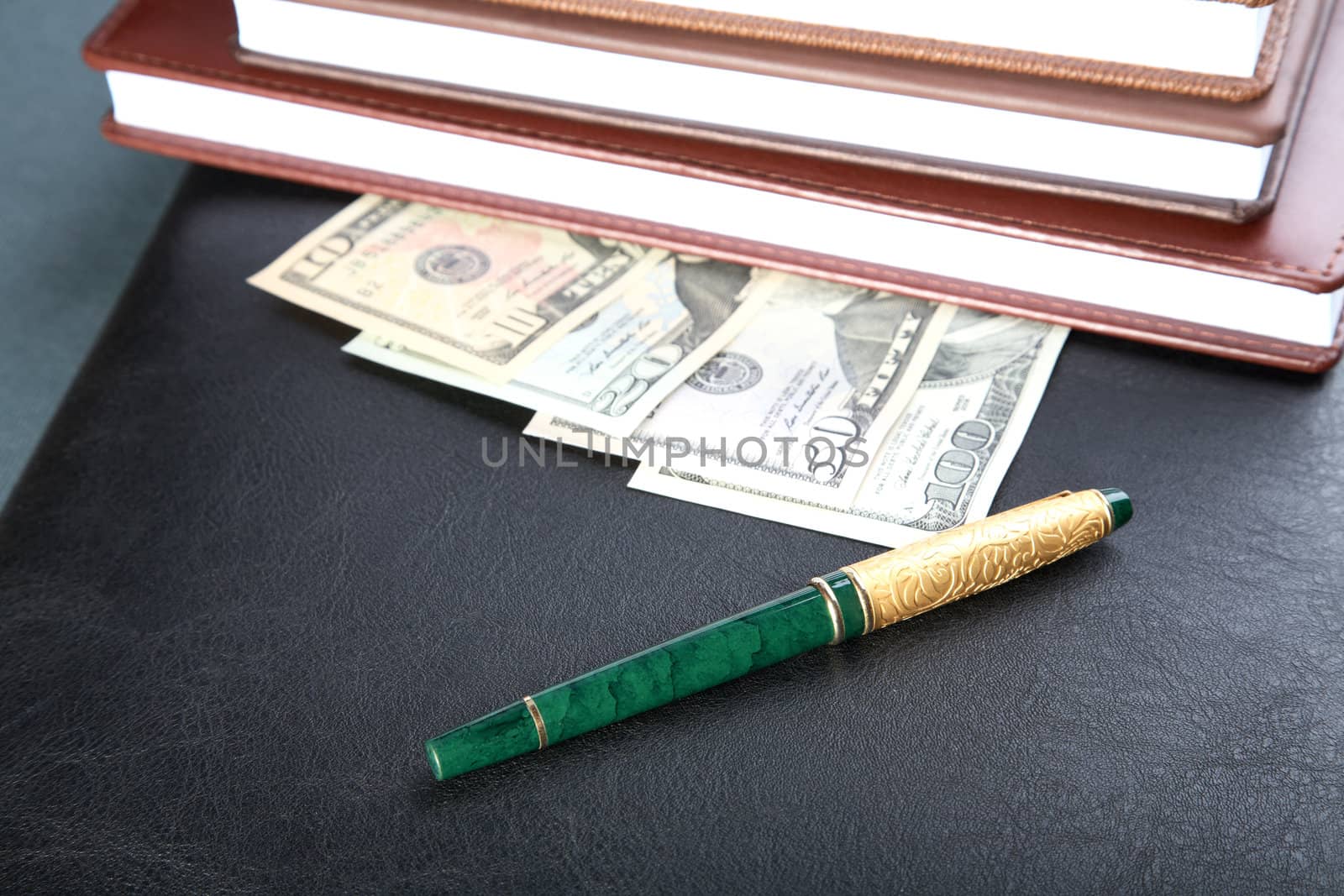 Folder organizers  pen and money on a table