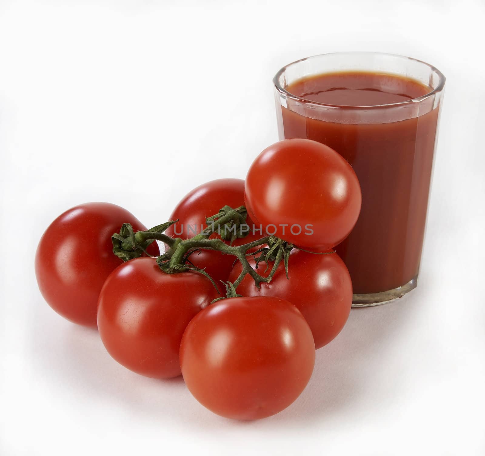 Tomatoes with juice on a white background