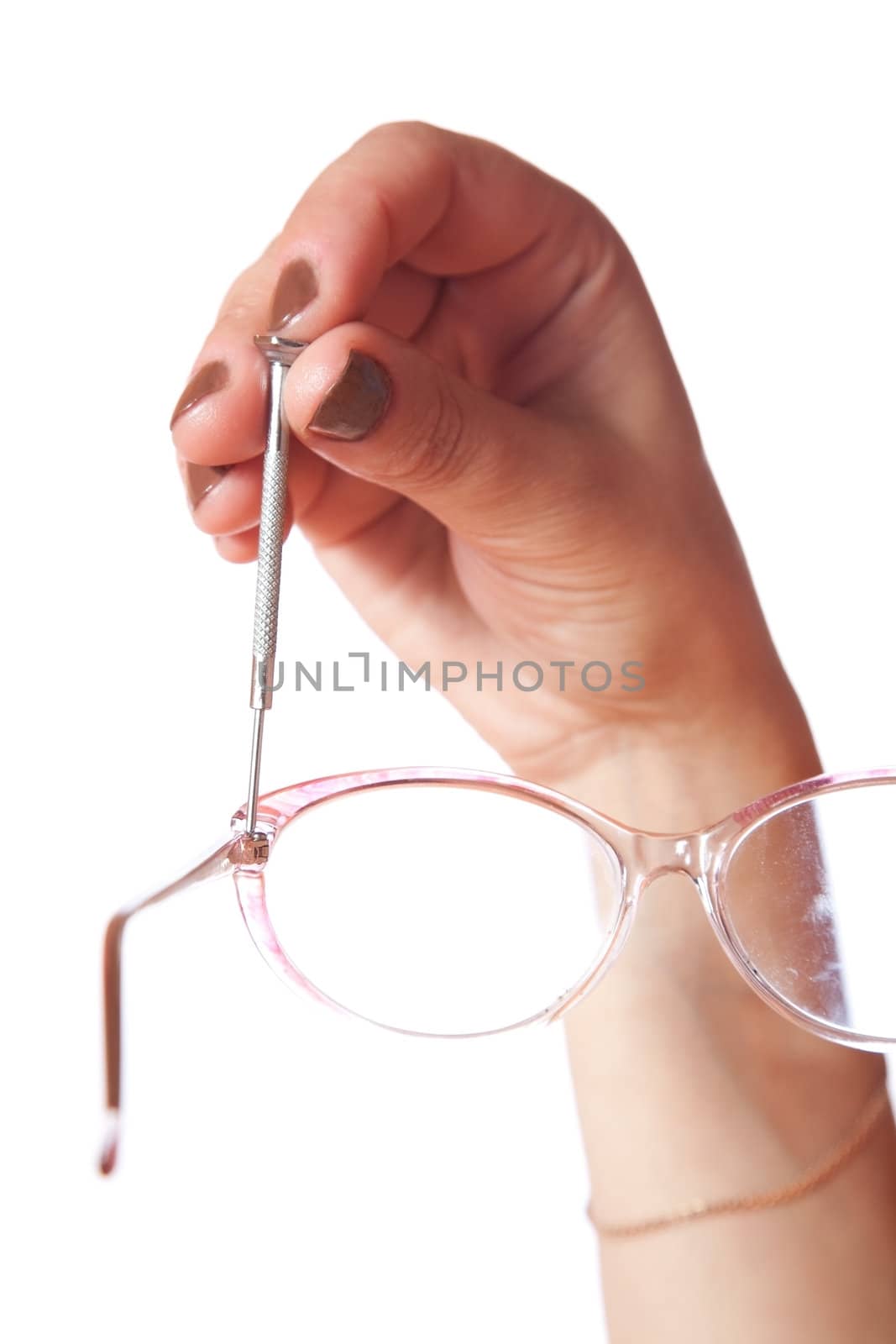 Female hand with screw-driver and glasses on a white background