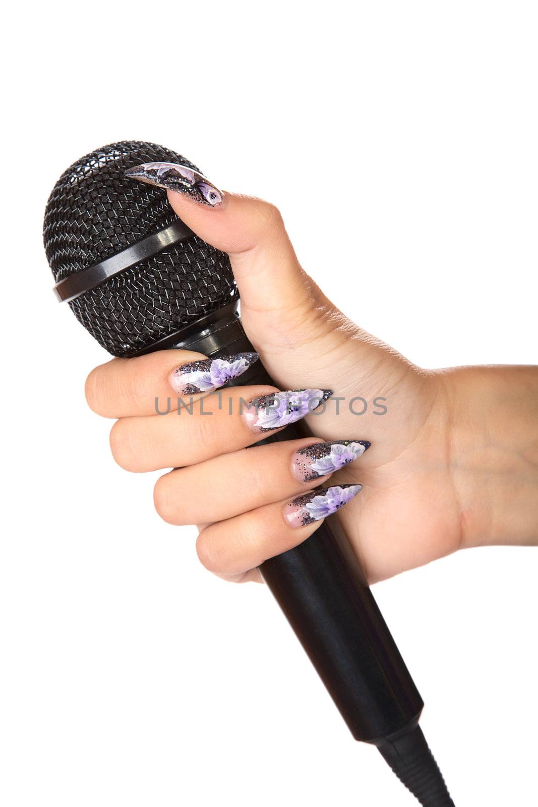 female hand with manicure holds  microphone isolated on a white background