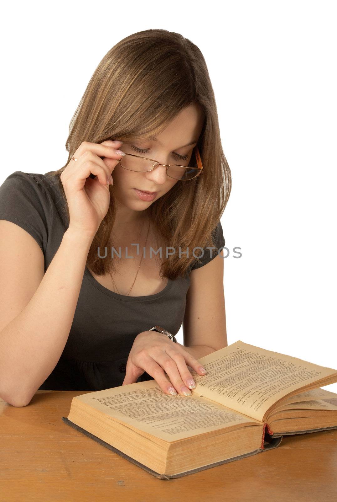 The girl in glasses reads the book on a white background