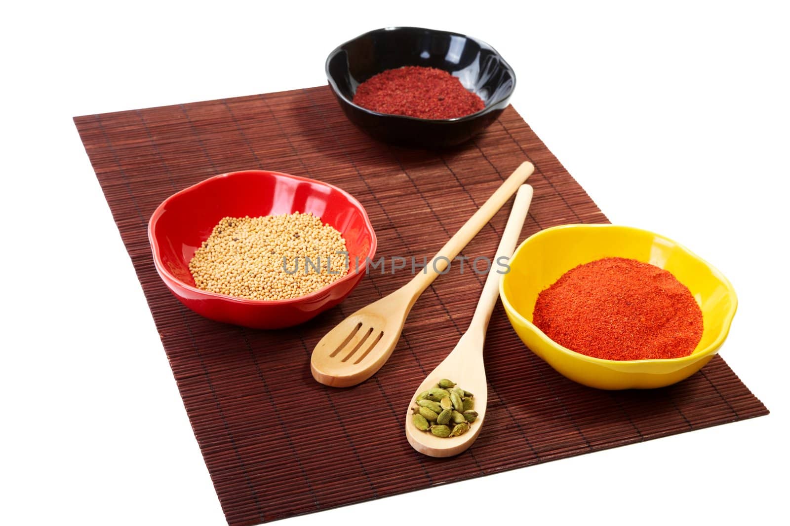 Still-life with spices in plates on a white background