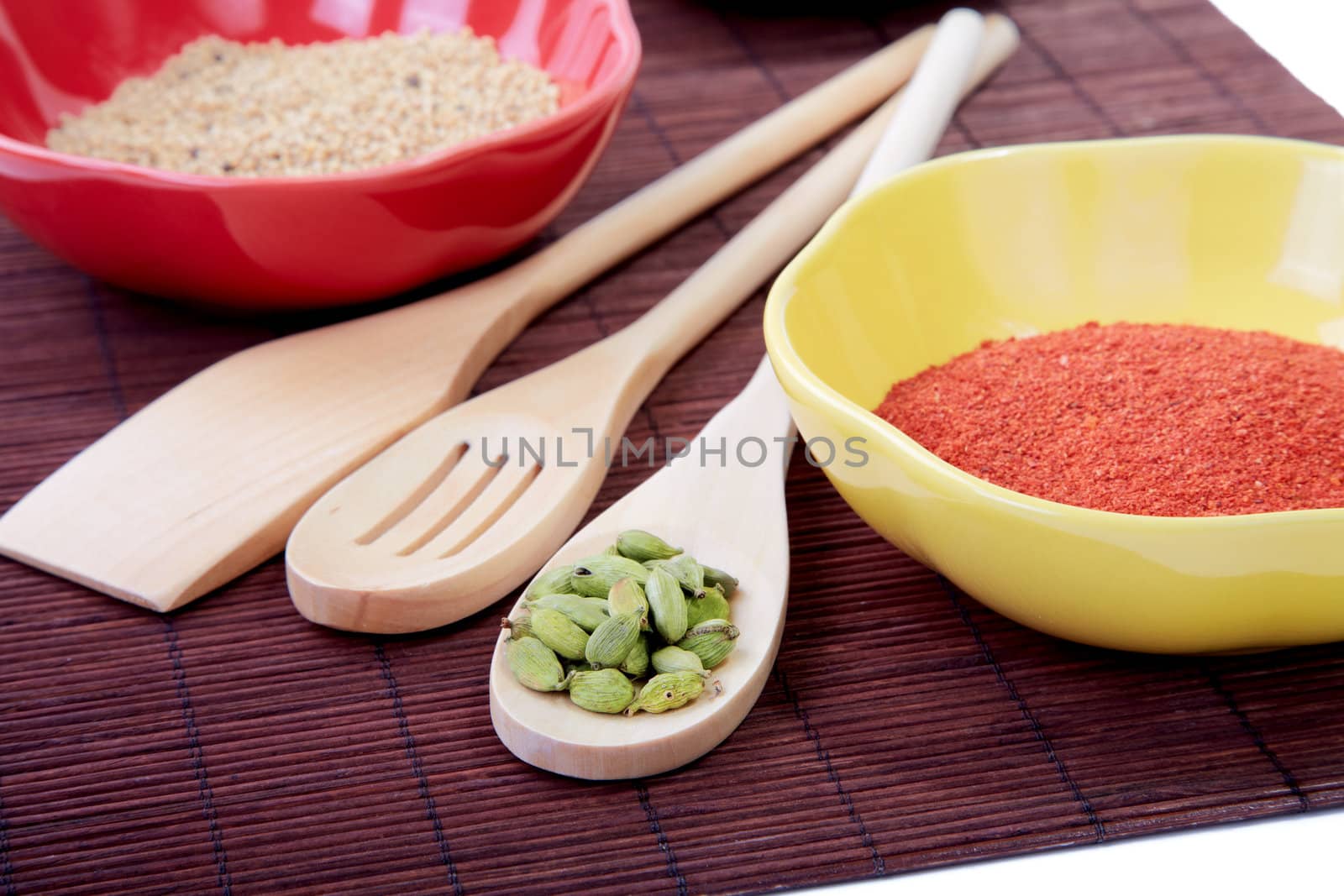 Still-life with spices in plates on a white background