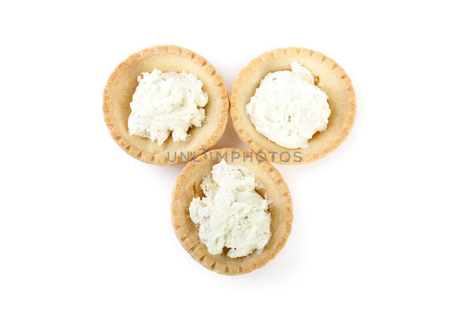 Tartlets with soft cheese isolated on a white background