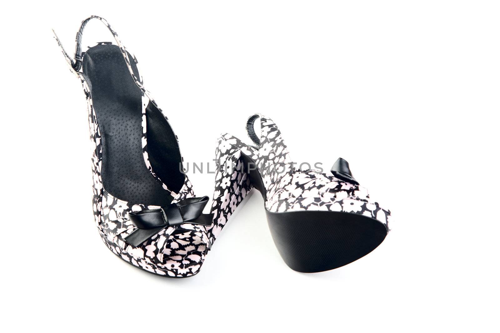 pair of female shoes on a high heel  white background