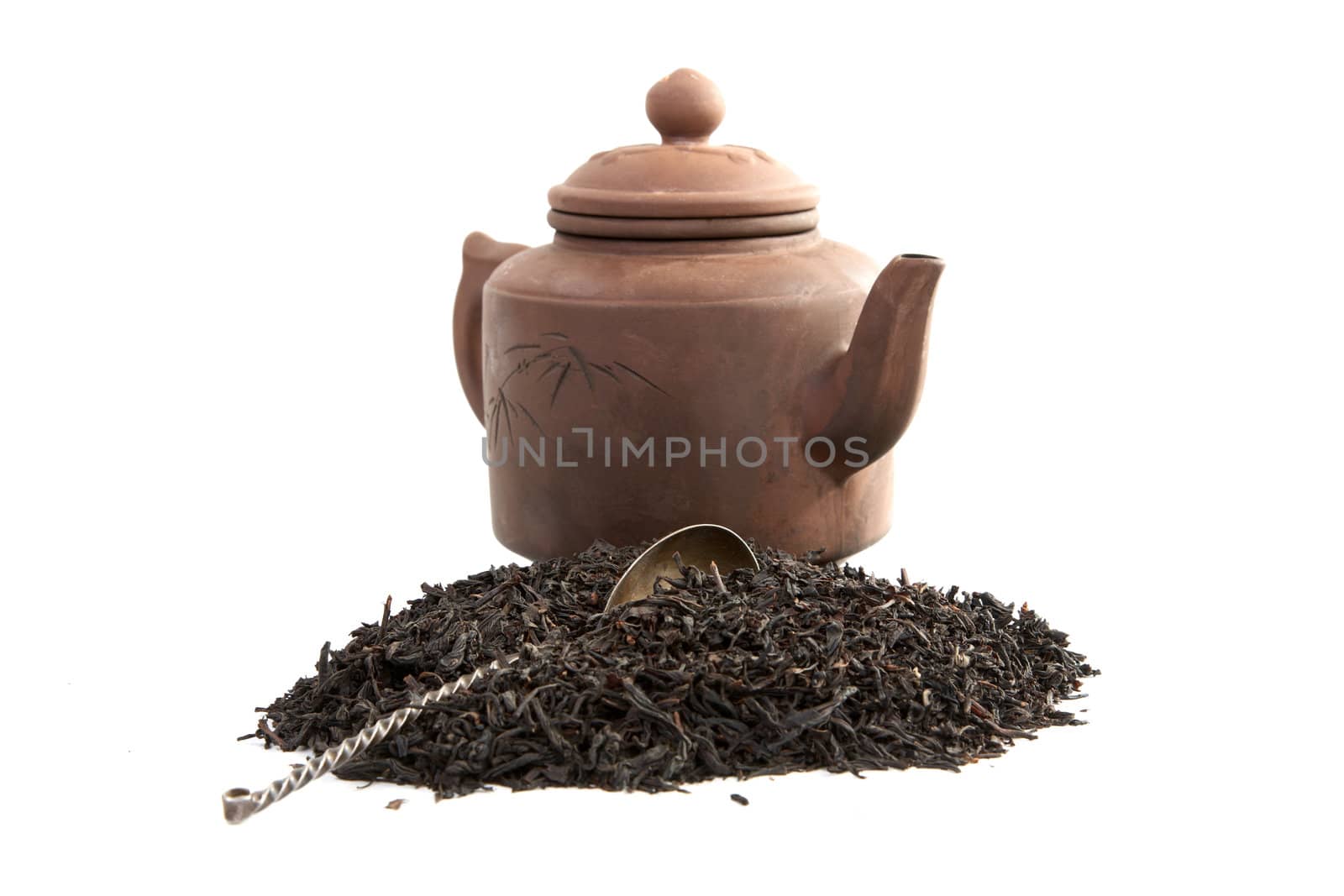 Teapot of the spoon and tea on a white background