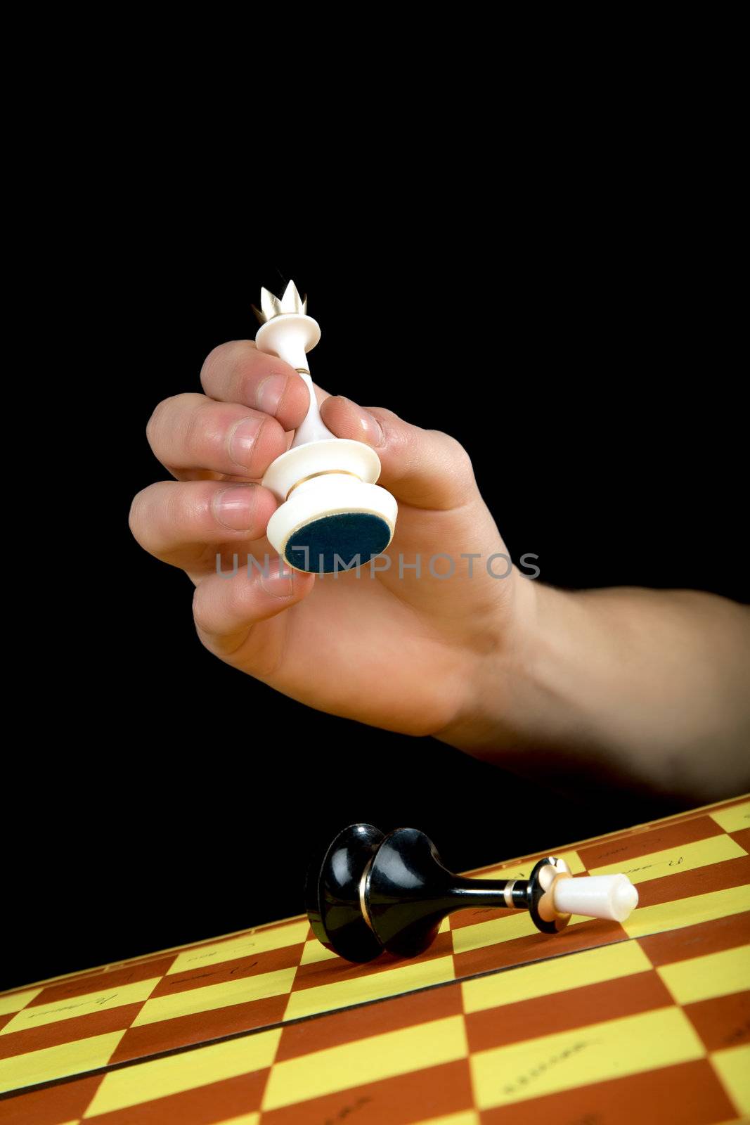 The man's hand with a queen gives checkmate to the black king