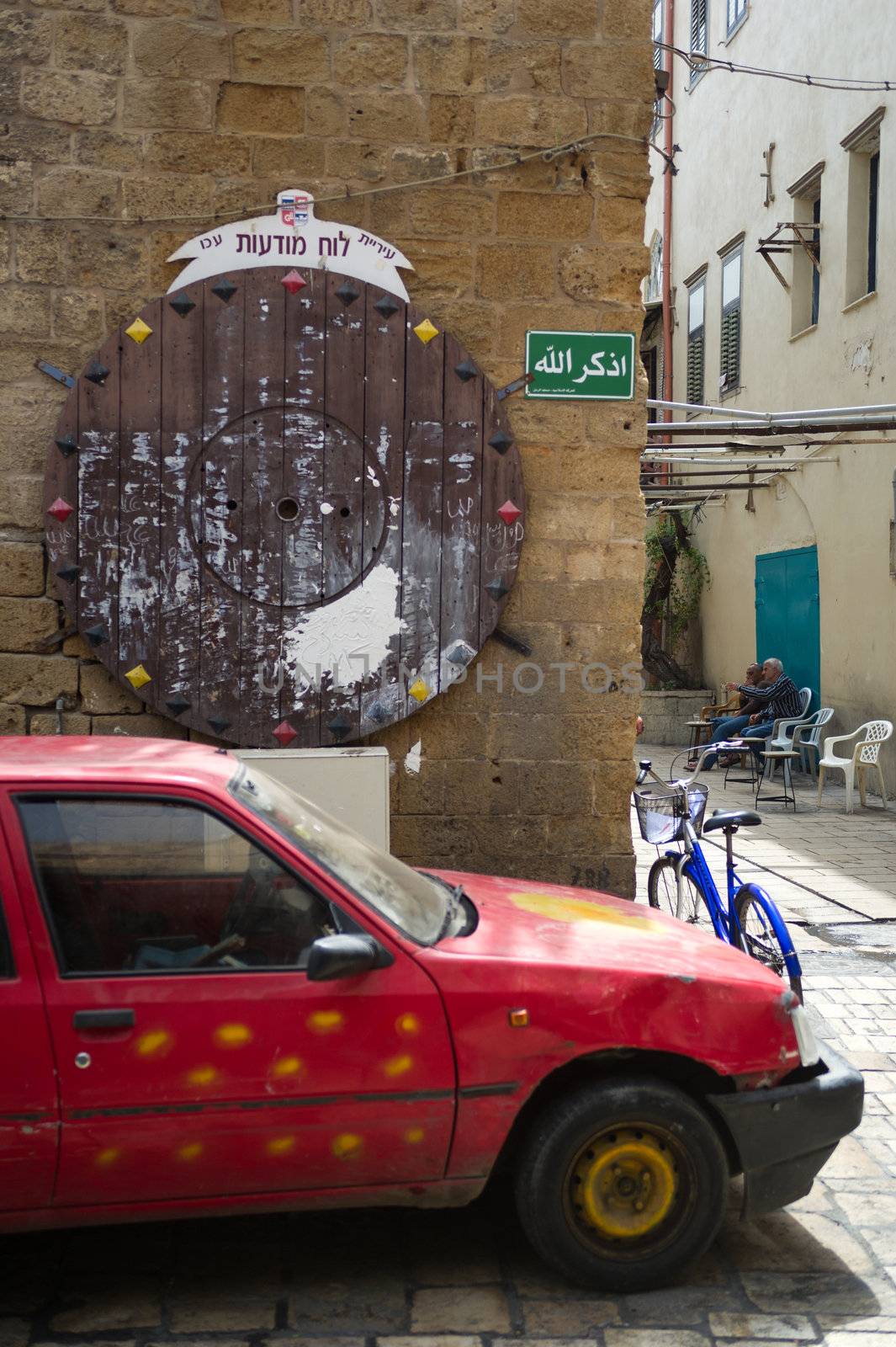 Empty round bulletin board on the old street in historic part of Akko, Israel