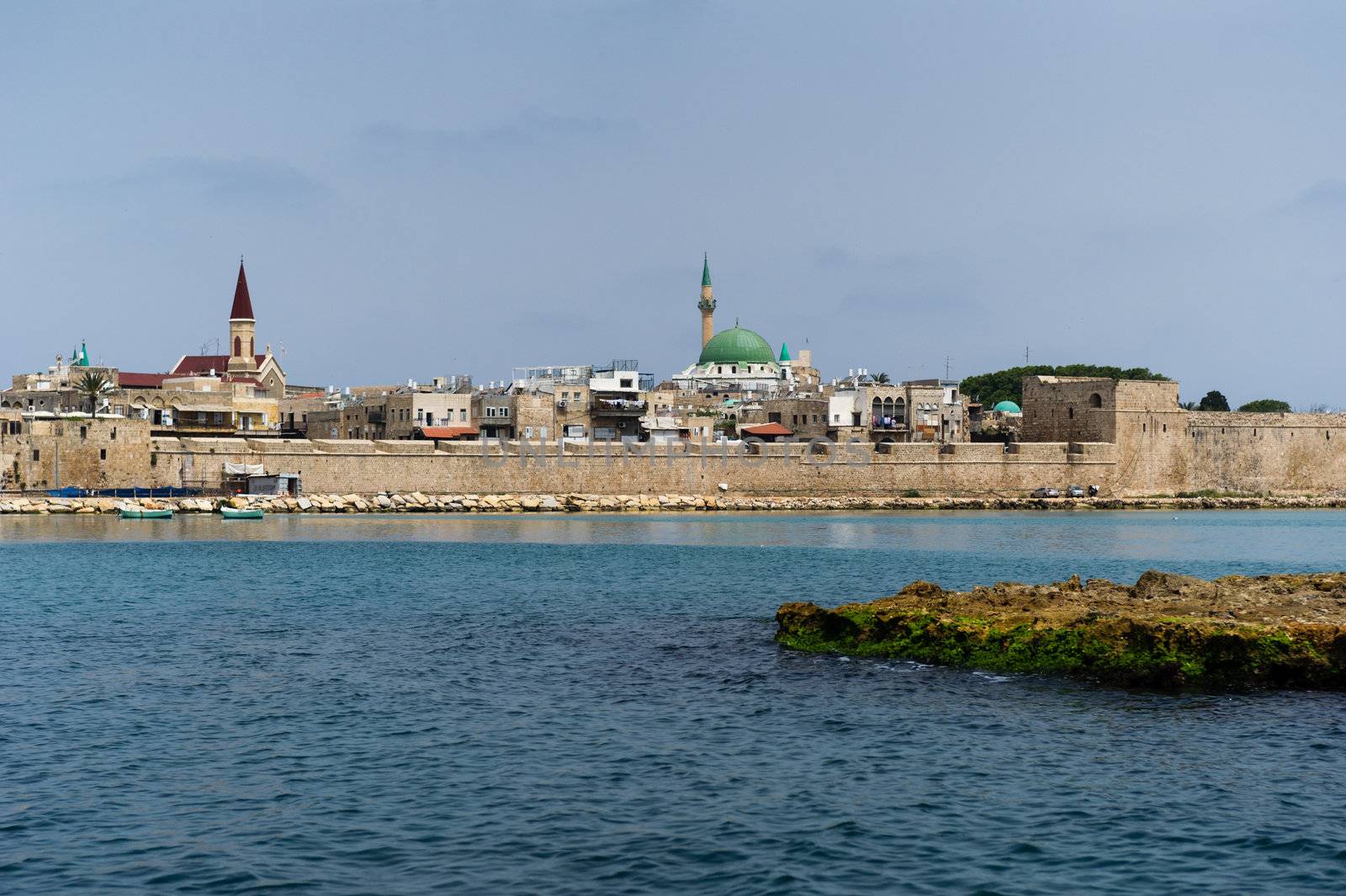 View on the ancient walls, houses and mosque in old town of Akko, Israel