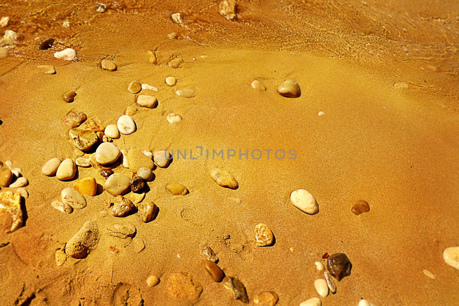 Pebbles on a sand sea shore