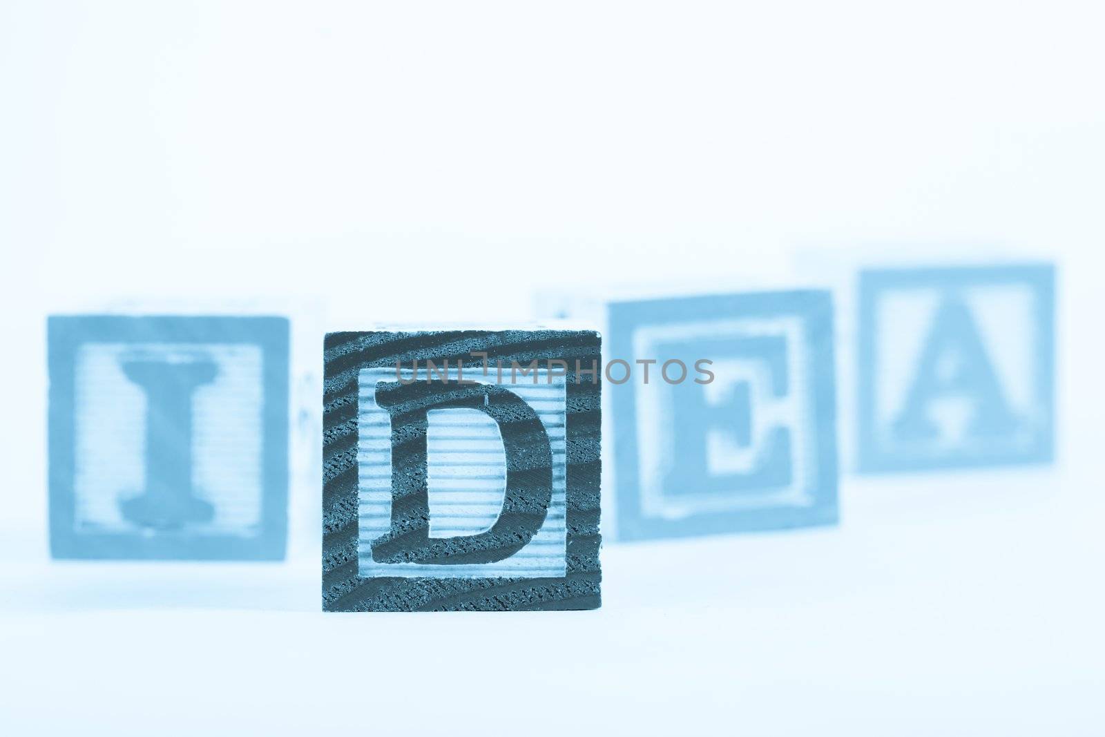 Word "idea" made from alphabet blocks on white
