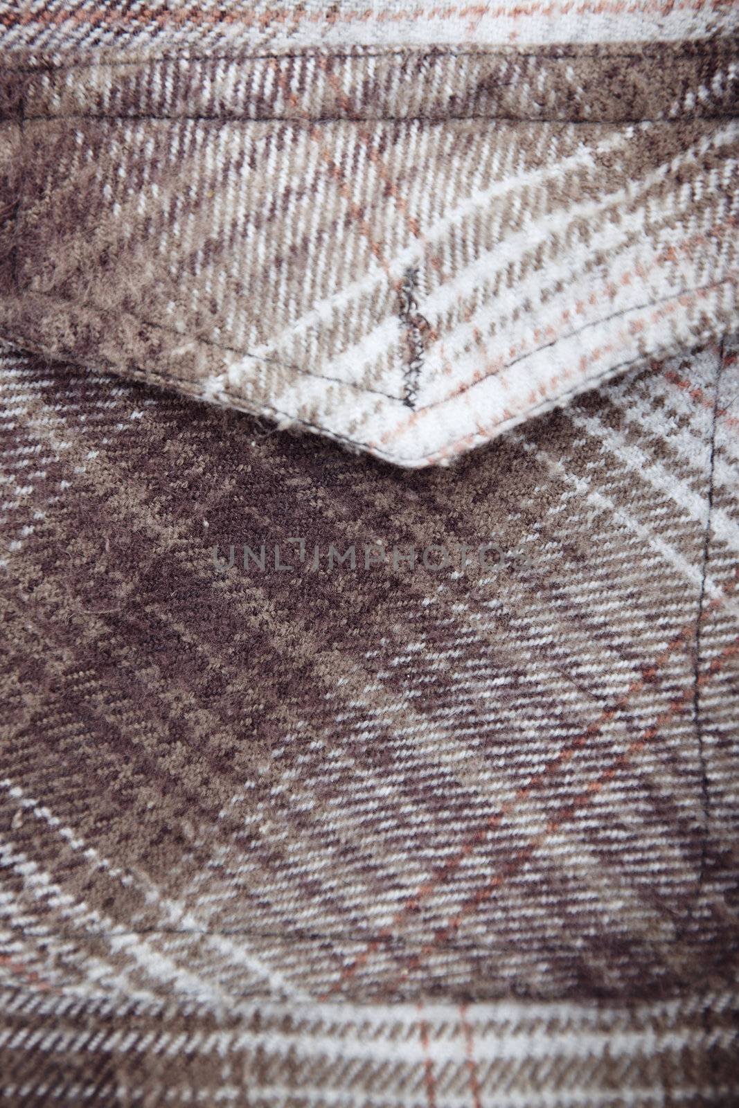 Pocket of woolen shirt. Close-up color photo