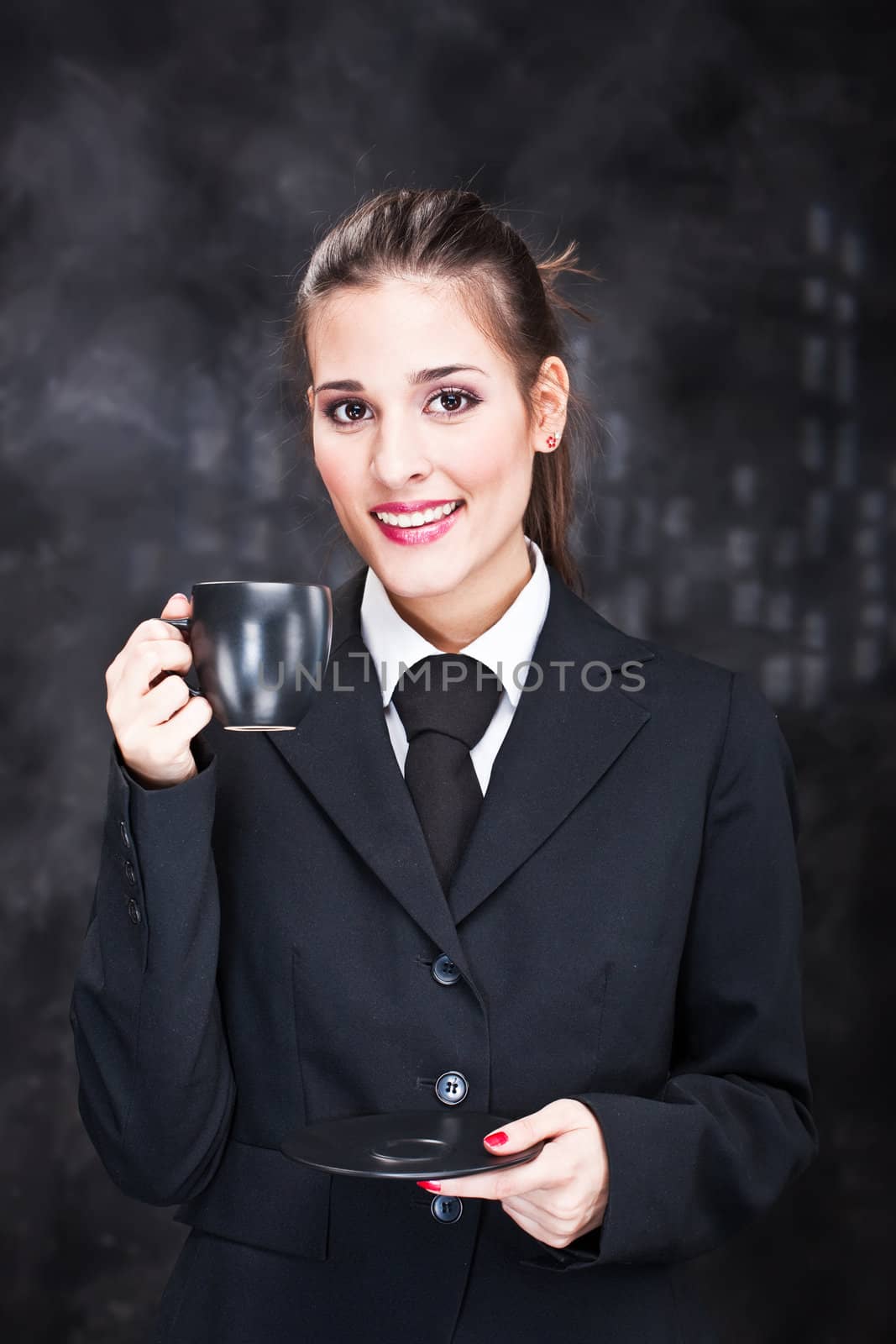 Pretty young woman holding black cup of coffee