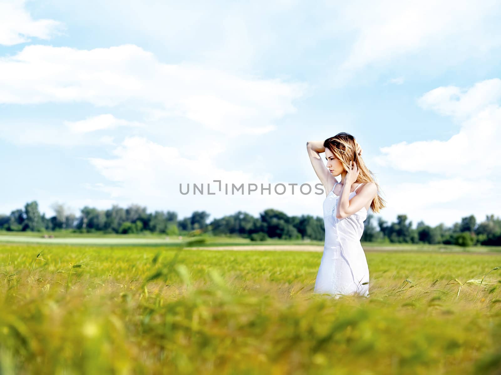 Woman at wheat field on sunny day by imarin