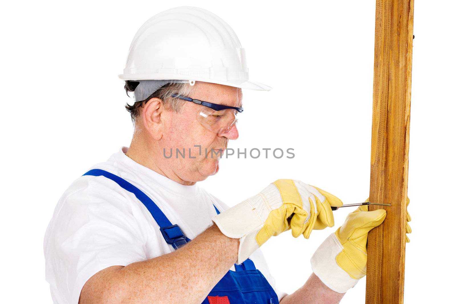 Middle age worker screwing nail in board, isolated on white background