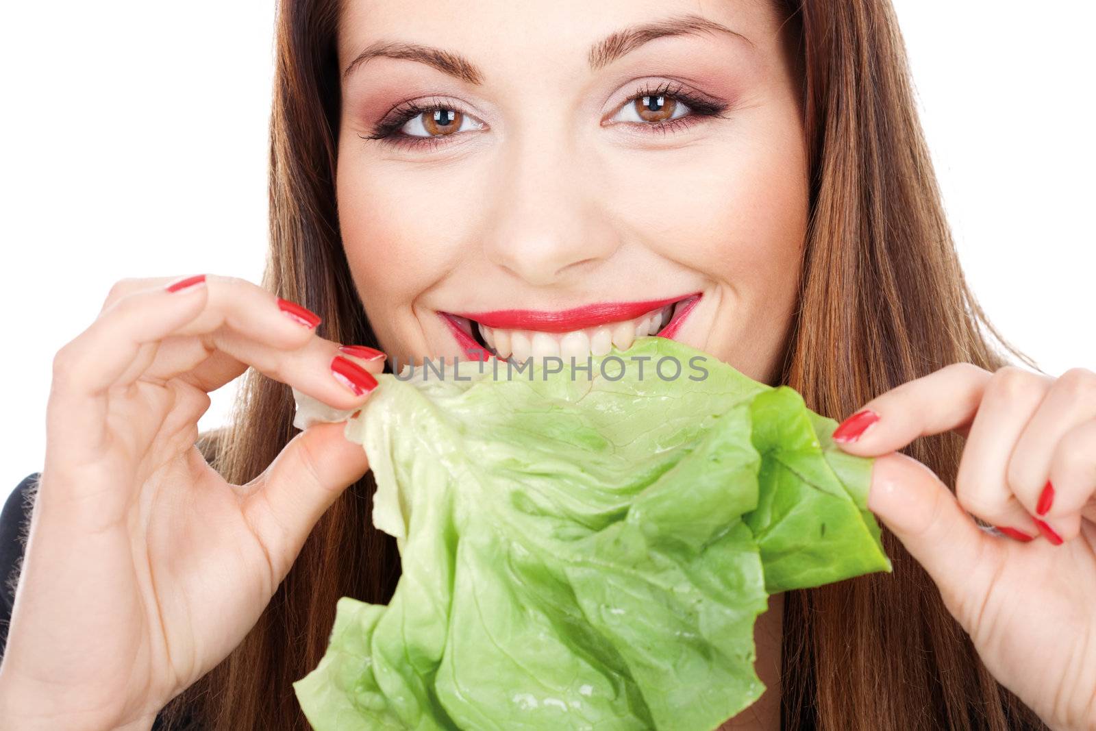 close up look of brunette woman eating green salad, isolated on white