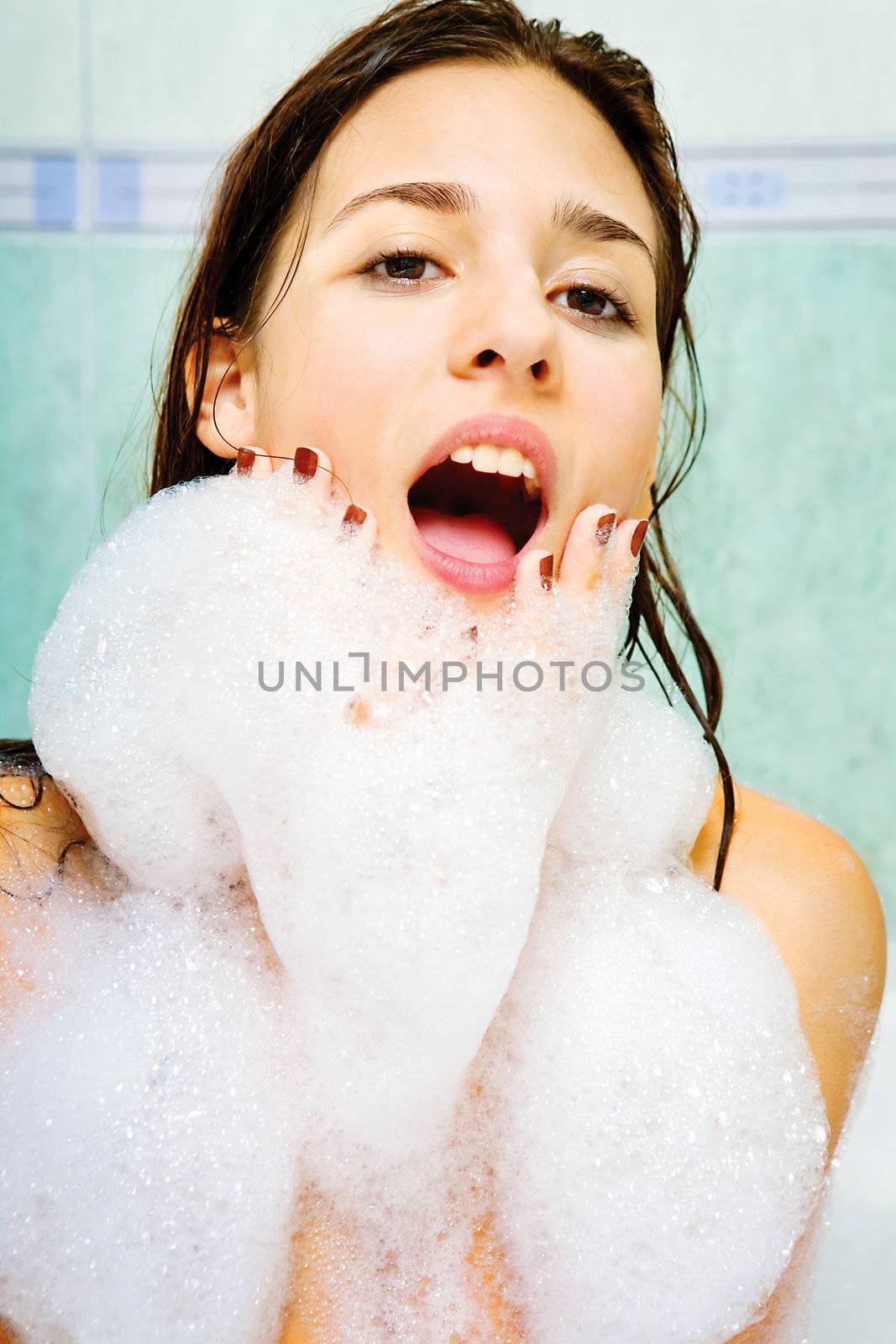 Close up of a young woman enjoy in bathtub with foam all around