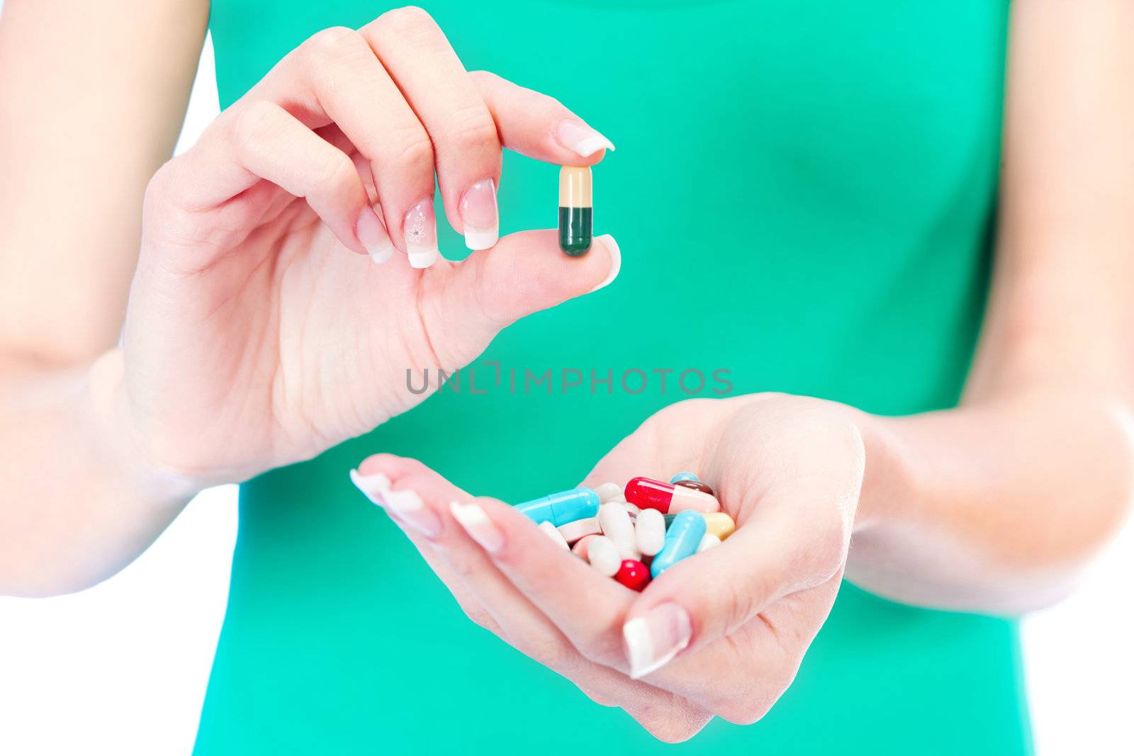 capsules in woman's hand by imarin